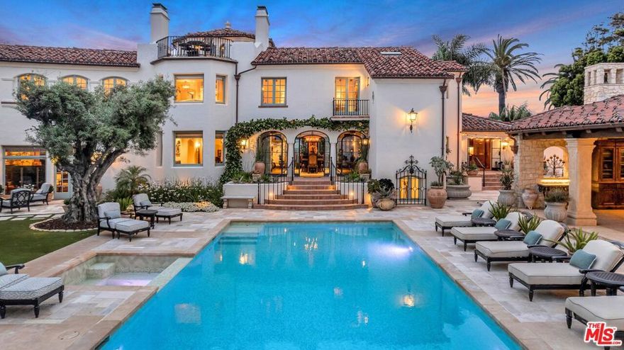 This stunning Spanish estate sits on a palm-lined promenade just 100 feet from the beach, on one of the largest lots in Coronado. The historical landmark encompasses a 13,129 square-foot main house, sprawling guest house, and private garden sanctuary with tranquil fountains and estancia. Originally built for business magnate W.A. Gunn, the four-bedroom (option for five), eight-bathroom abode features vintage Hollywood glamour adorned with state-of-the-art amenities for optimal luxury living space, replete with castle-like characteristics. Conceived by the illustrious Richard Requa in 1925, the previous owner preserved priceless historical heritage. Dominated by an impressive turret that acts as an entrance hall, the home's exotic allure is undeniable, revealing a stunning foyer with a spiral staircase and striking, hand-hewn beams. Echoing the kind of extravagance that underscored the 1920s, "Coronado Castle" perfectly captures the era's zeitgeist, rife with opulent tile flooring, ornate ironwork, and stained-glass touches. An immaculately hand-painted coffered ceiling dominates the formal dining room, punctuating the voluminous expanse that bleeds outward to the pool deck via a trio of custom steel glass doors. Grounded in reclaimed 18th-century European terracotta tile, Spanish embellishments abound. A capacious kitchen is poised for entertaining, appointed with an 80-inch La Cornue range and rotisserie, double Subzero fridge, Miele steam oven, and coffee station, plus a wet bar. Illuminated by custom light fixtures, the kitchen is anchored by an immense marble island. Preserving period details while meticulously updating the home to modern-day standards, historically accurate embellishments have been implemented throughout. Reimagined with an opulent mix of rare finishes and Moorish tiling sourced from around the world, new renovations masterfully mirror Requa's original concept and inspirations. Evoking a 5-star feel with a firepit lounge, wet bar, and dining area, the turret's third-floor roof deck affords panoramic ocean views. The lavish basement is just as impressive. Designed with a grand staircase and soaring ceilings, the voluminous expanse boasts a golf simulator, media room with bar, trophy room, 25-seat movie theater with projector, 1,300+ SqFt world-class gym, and full spa with dry sauna, massage table, and ice bath. Inducing an air of timeless luxury, a stunning pool deck sets the stage for summertime soirees, complete with 250-year-old stonework, Moorish ironwork, a full outdoor kitchen, and dining estancia. The lush oasis includes 100-year-old rustic olive trees, three fountains, a putting green, a secret garden, and a dog run. Perfect for out-of-town guests, a detached guest house is equally sumptuous, appointed with a full bathroom and kitchen. Celebrating the spirit of Requa's original design while fully embracing modern-day convenience, this historic home is a part of the Mills Act, which allows for reduced property taxes. Thoughtfully updated with a four-car garage with golf cart parking, the estate includes an additional five coveted off-street parking spots a rarity in beach enclaves. A legacy estate that offers unmatched attention to detail, this is your chance to own one of the most sought-after exclusive properties in Southern California.