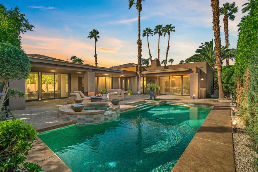 THE EPITOME OF DESERT ELEGANCE IN PRESTIGIOUS PAINTED COVE! Embrace refined sophistication in this exquisite contemporary home, perfectly nestled on a serene corner lot within the exclusive gated enclave of Painted Cove in La Quinta. Offering 3723 Sq Ft of beautifully curated living spaces seamlessly blending privacy, luxury and effortless indoor-outdoor living at  its finest! A grand arrival begins at the bronze and metal double doors opening to an airy, light filled floor plan that exudes understated elegance. The living room and dining room combination serve as the heart of the home flowing gracefully into the family room, creating a sense of volume, connection and warmth. The ideal setting for both intimate gatherings and grand scale entertaining! The open chef's kitchen is where form meets function, recently elevated with premier sub zero refrigeration, Wolf gas cook top, Wolf high speed oven with 2 warming drawers and a Cove dishwasher completed by a lovely breakfast nook and breakfast bar. Delight in high ceilings, expansive windows and refined finishes that enhance the contemporary ambiance, while new interior paint, luxury vinyl plank flooring throughout add modern cohesive sophistication. Thoughtfully designed, this home features 4 bedrooms and 5 bathrooms ensuring comfort and privacy for all. The generously sized attached casita, with private entrance, provides a serene retreat for guests. The primary suite is a true sanctuary with an oversized walk in closet, spa inspired bathroom with double vanities, new stone flooring and separate shower and tub. Each guest room is an ensuite with one transformed to a refined home office. Not to be forgotten is the interior laundry room with newer appliances. The three car garage has been refreshed with flooring recoated. The third car garage also functions as a personal gym with an mini split A/C! OUTDOORS discover a private resort style oasis around the entire home, framed by lush low maintenance landscaping. The sparling pool/spa beckons relaxation, supported by a  high efficiency Pentair pump and Aquastar filtration system! Electric retractable awnings create shaded retreats ideal for alfresco dining, quiet morning or sunset gatherings! Abundant serenity, beauty and impeccable design can be found here! Close to amazing golf, fine dining, shopping and the Indian Wells Tennis Gardens! LUXURY. GRACE. LIFESTYLE is what you find here at Painted Cove in La Quinta!!