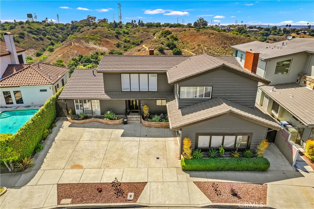 Exceptional Opportunity in Baldwin Hills Estates! Discover this stunning 3 bedroom, 3 bathroom residence, nestled within the highly sought-after Baldwin Hills Estates neighborhood. Spanning approximately 2,938 square feet of refined living space on an 8,050-square-foot lot, this home offers a versatile and luxurious lifestyle.
The thoughtfully designed floor plan features two bedrooms on the main level, while a third bedroom, connected by a Jack and Jill bathroom, is located upstairs. The bright, open layout seamlessly connects the living room with fireplace, dining area, and a kitchen that opens to a welcoming family room. An additional bonus room offers flexibility as a fourth bedroom or a home office.
Outside, a sparkling pool with a depth ranging from 4 to 12 feet provides a refreshing retreat. The expansive upstairs patio deck invites you to savor the breathtaking views of Los Angeles and the surrounding mountains. The home also boasts a large entertainment room with a wet bar and fireplace, accessible from the exterior patio stairs, making it perfect for hosting gatherings.
A spacious two-car garage with a work area, ample storage space, and a generous driveway ensure convenience and practicality. Recent upgrades include a HVAC system, updated electrical panel, sealed outdoor staircase, resurfaced pool, and a resealed upstairs patio.
Located minutes from Kenneth Hahn Park, Windsor Hills Walking Park, LAX, Baldwin Hills Mall, Metro Line, and other local attractions, this home offers unparalleled convenience. This property presents a unique opportunity for a new owner to bring their vision to life or for an investor seeking a remodel. The possibilities are endless!
