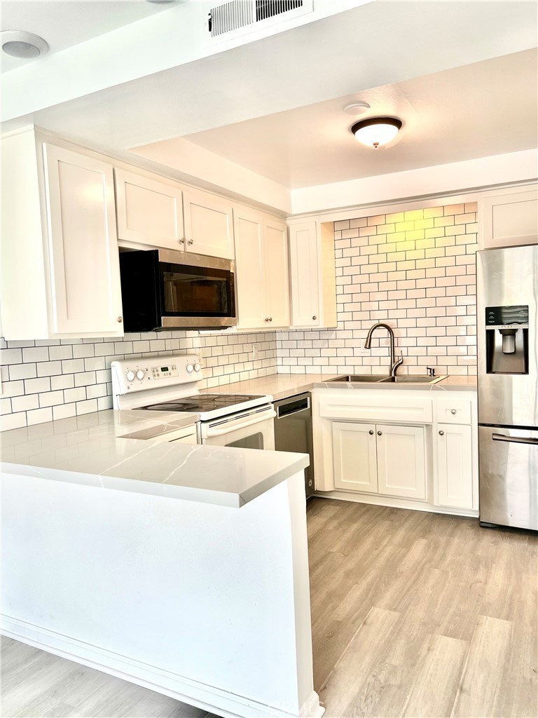 SINGLE Story 3BR + 2BA, only 1 common wall, NEWLY upgraded Wood Flooring, NEWLY upgraded Kitchen Countertop with breakfast bar, NEWLY upgrade bathroom and Shower. PREMIUM location with community pool view. Include 1-car garage and one car parking permit. GATED Community with pool, clubhouse, and community laundry. But this house provide the Inside Laundry at the 2nd Bath. Refrigerator, Washer and Dryer are INCLUDED. Water and Trash are INCLUDED. Located near Shopping, Dinning, Entertainment, Walk to School and minutes to Freeway.