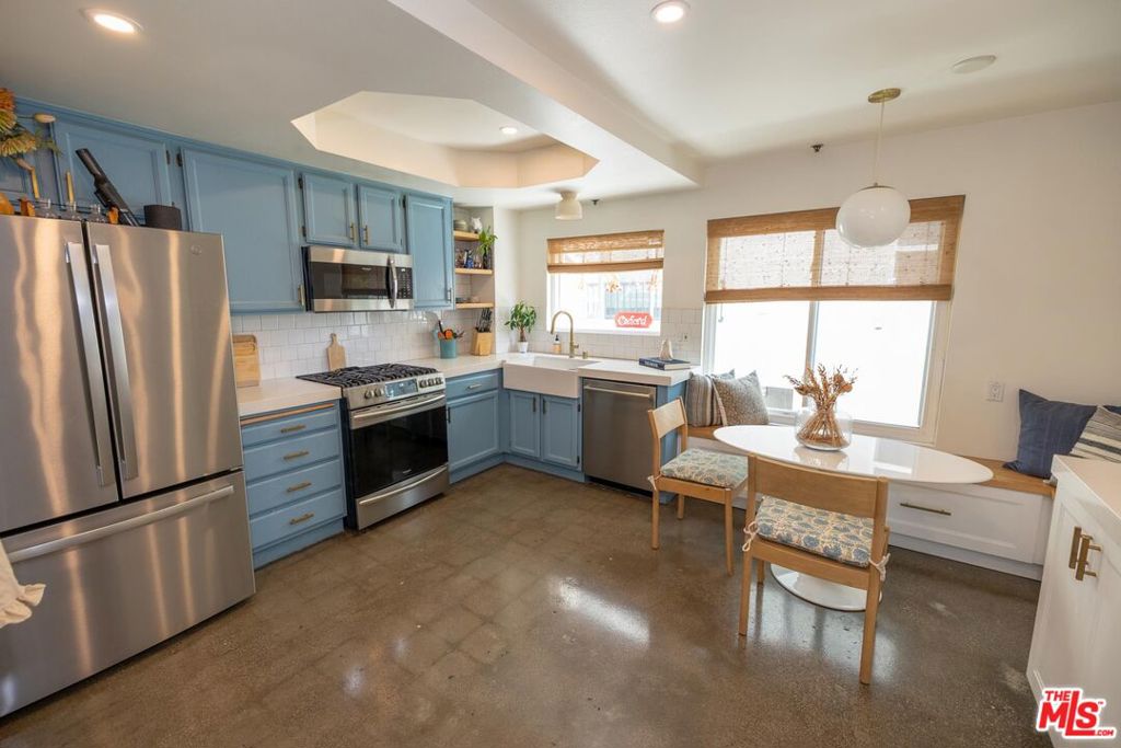 Move-in Ready Townhome in Prime Toluca Woods!Welcome to this immaculate tri-level townhome offering 2 bedrooms + office, 3 bathrooms, and 1,925 sqft of beautifully designed living space. Nestled in the sought-after Toluca Woods neighborhood, this meticulously maintained home comes with high-end renovations and custom finishes throughout home. Newly remodeled kitchen with quartz countertops, stainless steel appliances, custom built-in seating, and ample cabinetry. The spacious living room showcases polished cement floors, recessed lighting, a cozy fireplace, and a dry bar perfect for entertaining. Upstairs, you'll find two generous primary suites with solid hardwood floors, large closets, and en-suite baths. One suite boasts a 2024 bathroom remodel complete with a marble mosaic floor, walk-in shower, freestanding tub, double vanity, and a private balcony. The lower level includes a versatile bonus room ideal for an office, gym, or creative space, along with an in-unit laundry room and extra storage. Additional highlights include energy-efficient windows with a lifetime warranty, a private rooftop deck for al fresco dining or movie nights under the stars, and a dedicated EV charger plug. Located in a secure, well-maintained building just minutes from Toluca Lake, Warner Bros, and Universal Studios.