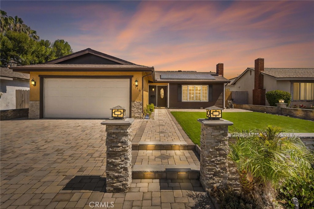Welcome to this inviting and beautiful 4-bedroom, 2-bathroom home offering 1,616 sq ft of comfortable living space and thoughtful upgrades throughout. The spacious living room is filled with natural light from large front windows adorned with plantation shutters and centers around a cozy gas fireplace—perfect for relaxing or entertaining. The remodeled kitchen is a true standout, featuring granite countertops, a large island, stainless steel appliances, and a seamless flow into the dining area and family room. Enjoy the convenience of an indoor laundry room with direct access to the attached 2-car garage. A whole house water filtration system is an added bonus! Step outside to a low-maintenance backyard with attractive pavers and yard drains, while the front yard boasts artificial turf, accent lighting, a beautifully landscaped design with a drip irrigation system, and a paver driveway and walkway with tasteful stone accents and lighting—offering exceptional curb appeal. This home also includes a Tesla solar lease, providing energy efficiency and potential savings. Don’t miss this opportunity to own a home that combines style, function, and eco-conscious features without any HOA dues!