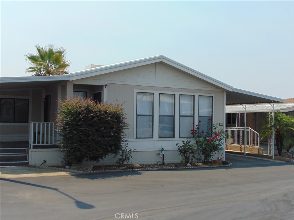 One of Yucaipa"s most desirable 55+ community. Beautiful triple wide. View of the mountains through the large windows in the living room. Open floor plan to dining area and kitchen. separate office area in living room with built in desk. Newer laminate flooring and carpeted flooring and newer carpet in bedrooms. Cathedral ceiling. Dining area with built in lighted hutch. Kitchen has separate dining area and lots of counter space plus lots of storage. Dual sinks, filtration system. Tile counter tops. Gas range, side by side refrigerator. Slider in Kitchen area to the 3rd bedroom. Could also be used as an office/craft or what you want it to be. Has a closet and electric heater. Has it's own entrance to outside. Larger bedrooms, mirrored closet door in Master bedroom. walk in closet with two entrances, Shower over tub. Bidet, toilet. marble counter, dual sinks. Guest bedroom has large walk in closet. Ceiling fans. Dual pane windows, Individual extra large laundry room, with more storage and vanity. Deep sink. chaulk board and pin bulletin board. Entrance to driveway. Wait, There's more, 2 sheds for extra storage too. Amenities in the park include Water, sewer and trash. Spa, swimming pool. and dog park. Appliances included except for no washer. TV in living room also included. Home has both swamp-evaporative cooler and central heat and air. Sprinkler drip system. 3 parking spaces Security gate for entrance to Yucaipa Land Yacht Harbor. This is a member park, where you own an RV for at least a year. HOA is $195 for members, $650 for non. RV parking available. Must have park approval.