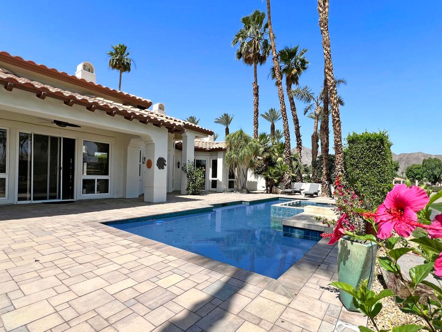 Nestled within prestigious Rancho La Quinta Country Club. Gorgeous modern renovated home with stunning views of the colorful hues of the panoramic Chocolate Mountains & the 9th. fairway of the Robert Trent Jones Jr. Championship Golf Course.  Ideally situated on a private cul-de-sac & close to the Club House & all of the amenities. The large backyard entertainer's covered patio features quality stone pavers, custom pool with elevated spa, waterfall & a large built-in BBQ cooking station.  This high end PALACIO II mini-estate consists of 4 bedroom, 4.5 baths. A deluxe detached guest house with a romantic fireplace & kitchenette offers guests privacy & comfort.  Upon entering the charming courtyard you will be greeted by hand-laid paving stones. Enter the beautiful custom wood glass dual doors and you will be impressed with the craftsmanship & attention to detail. This home has been almost completely retrofitted from top to bottom & has been re-envisioned & modified by removing the wall that separates the kitchen, family room-living room resulting in an amazing open floor plan concept that creates spaciousness with multiple entertainment venues.  Features boast updated limestone flooring & plush upgraded carpeting in bedrooms-all bedrooms are ensuite. Modern interior paint colors & modern ceiling fans enhance the ambiance, LED lighting throughout. The newly updated gourmet kitchen is a culinary delight with custom finished cabinetry, Quartz surfaces & beautifully designed contemporary backsplash & top of the line stainless steel appliances.  Entertain in style from the step-down wet bar complete with the same luxurious features of the kitchen.The elegant formal dining room with its newly installed modern electric fireplace provides a warm & cozy atmosphere for entertaining. The primary bathroom suite offers Quartz counter tops. a redesigned soaking tub & updated walk-in shower with frameless shower doors. The lavish primary suite with a romantic fireplace opens directly to the pool & spa & offers stunning views of the golf course. HOA dues of $1,198 per month include social membership, use of club house, two other dining facilities, 8 pickleball courts, 9 tennis courts, bocce ball, fitness center, 24 hr. roving security, direct TV, internet, front landscaping & trash. Note: some images have been virtually staged to better showcase the true potential of rooms & spaces. This is resort living at its finest in prestigious Rancho La Quinta Country​​‌​​​​‌​​‌‌​​‌​​​‌‌​​​‌​​‌‌​​​‌​‌​​​‌‌​ Club.