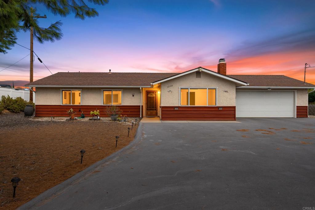 Welcome to 12166 Saddle Rock Road, a beautifully maintained single-story home tucked away on a quiet cul-de-sac in Lakeside. This 3-bedroom, 2-bath residence offers 1,504 sq. ft. of comfortable living space on a spacious 0.36-acre lot with panoramic mountain and sunset views. Inside, you’ll find an inviting family room with a cozy fireplace, upgraded bathrooms with granite counters and custom tile, and newer dual-pane windows for energy efficiency. The open layout flows seamlessly to the outdoors, where a redwood deck and concrete patio create the perfect setting for entertaining or relaxing in your private backyard, complete with fruit trees and low-maintenance landscaping. An attached 2-car garage plus additional driveway parking provide plenty of space for vehicles, RVs, or toys. With its combination of privacy, charm, and breathtaking views, this home is a true Lakeside retreat ready for its next chapter.