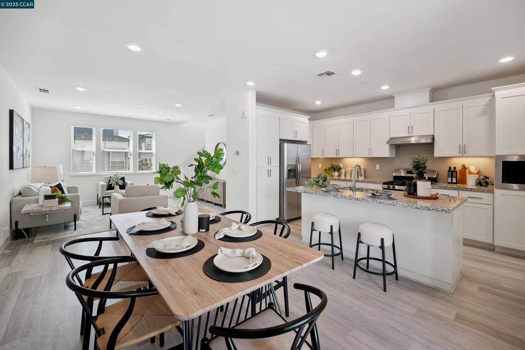 Welcome to 92 Zenith, a stunning townhouse style condo in the heart of Fremont. This beautifully designed condo offers 1,591 sq. ft. of thoughtfully laid out living space across three levels. As you enter, you’re welcomed by a versatile downstairs den, perfect for a home office, workout area, media room, or kids’ play space. Upstairs on the main level, you’ll find an open concept layout filled with natural light, featuring luxury vinyl plank flooring throughout. The chef’s kitchen boasts quartz countertops, stainless steel appliances, and upgraded cabinetry. Step out onto the private balcony to relax and unwind. The top floor includes three spacious bedrooms and two full bathrooms, including a primary suite with an en suite bath. A conveniently located laundry area with washer and dryer completes the upper level. Additional highlights include an attached two car garage with EV charger and close proximity to guest parking and the community’s outdoor BBQ area. Nestled between Mission Boulevard and Stevenson, this prime location offers easy access to both Highways 680 and 880, as well as BART, making commuting a breeze. Enjoy all that the community has to offer, including Lake Elizabeth just a short walk away, scenic trails, parks, shopping, and dining.