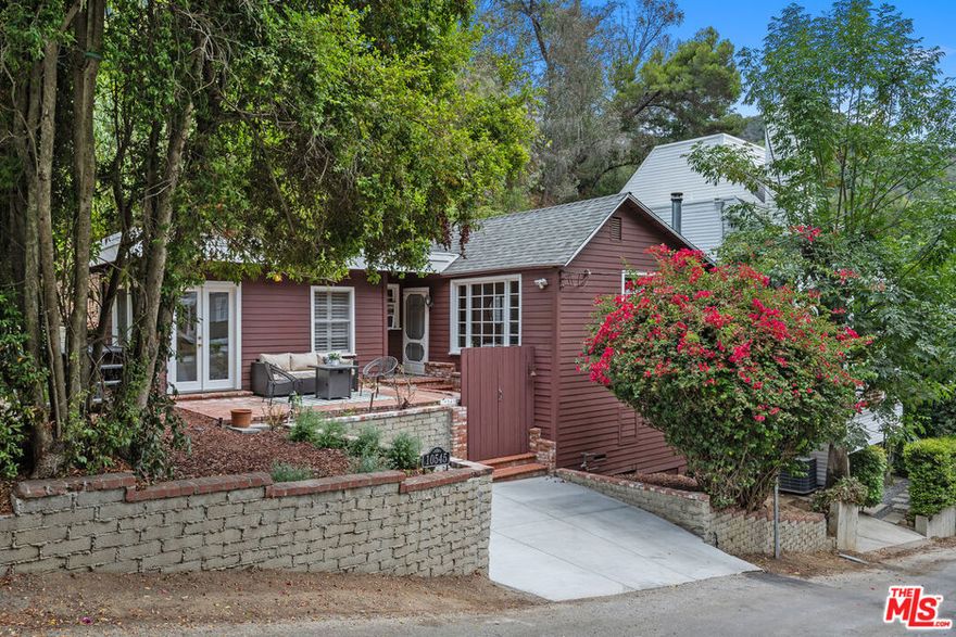 Tucked in the Bel Air hills, this storybook cottage oozes character and charm. Vaulted wood-beam ceilings and wide plank floors set the vibe, while the living room steals the show with its antique wood-burning stove and warm, rustic feel. Set on a quiet cul-de-sac just minutes from Sunset, it feels like a hidden escape, close to everything, yet totally its own world. A brick patio and front garden are made for slow afternoons in the sun, and the kitchen's cozy breakfast nook is basically begging for morning coffee hangs. The skylit bathroom with a clawfoot tub and pitched ceiling brings serious vintage magic. Romantic, private, and full of soul, this is one of those rare homes that just feels different.