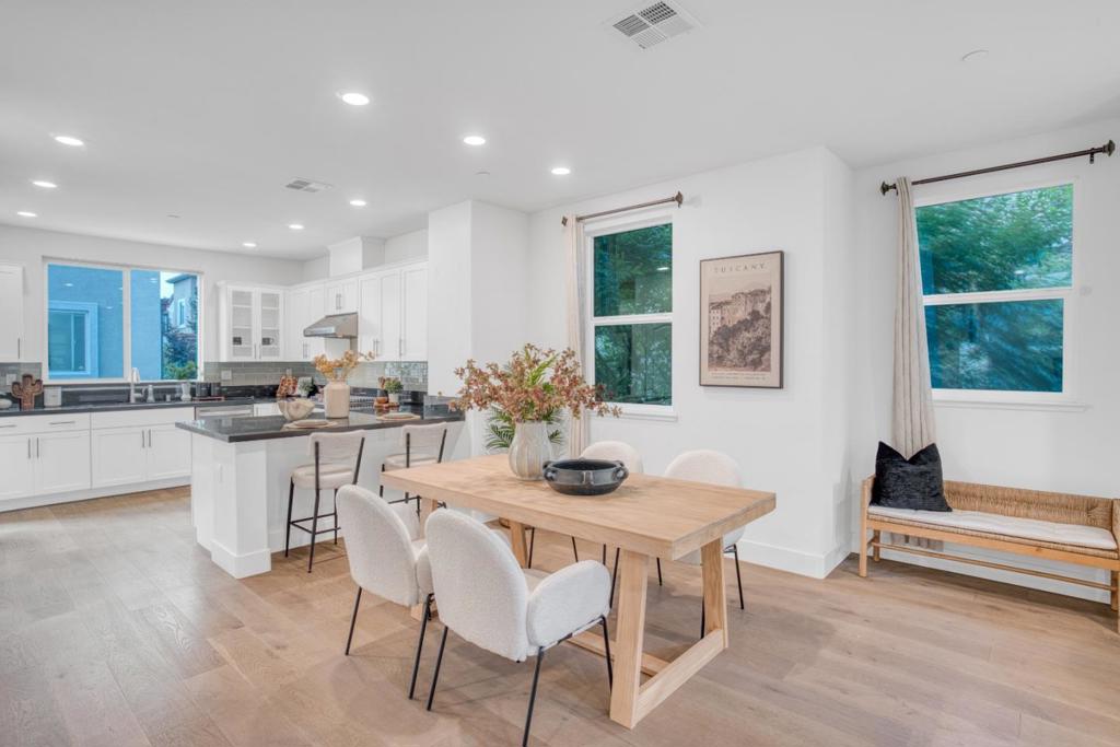 Welcome to this stunning end-unit townhome in the heart of Berryessa, offering modern comfort, abundant natural light, and a prime Silicon Valley location. With approximately 1,847 sq. ft. of thoughtfully designed living space, this 7-year-new home blends elegance, convenience, and low-maintenance living. The flexible floor plan begins with a private bedroom and full bath on the ground level ideal for guests, extended family, or a home office. Upstairs, the open-concept main level boasts a contemporary kitchen with quartz countertops, stainless steel appliances, white cabinetry, and a semi-island, seamlessly connected to the dining and living areas. A private balcony extends the space outdoors. The top floor features three bedrooms, including a spacious primary suite with a walk-in closet and spa-like bathroom with dual vanities. Additional highlights: recessed lighting, central A/C, EV-ready 2-car garage. Close to Berryessa BART, shuttle station for Meta, Amazon, Google, neighborhood parks, shopping plazas, Safeway, Ranch 99, Costco, and H-Mart.