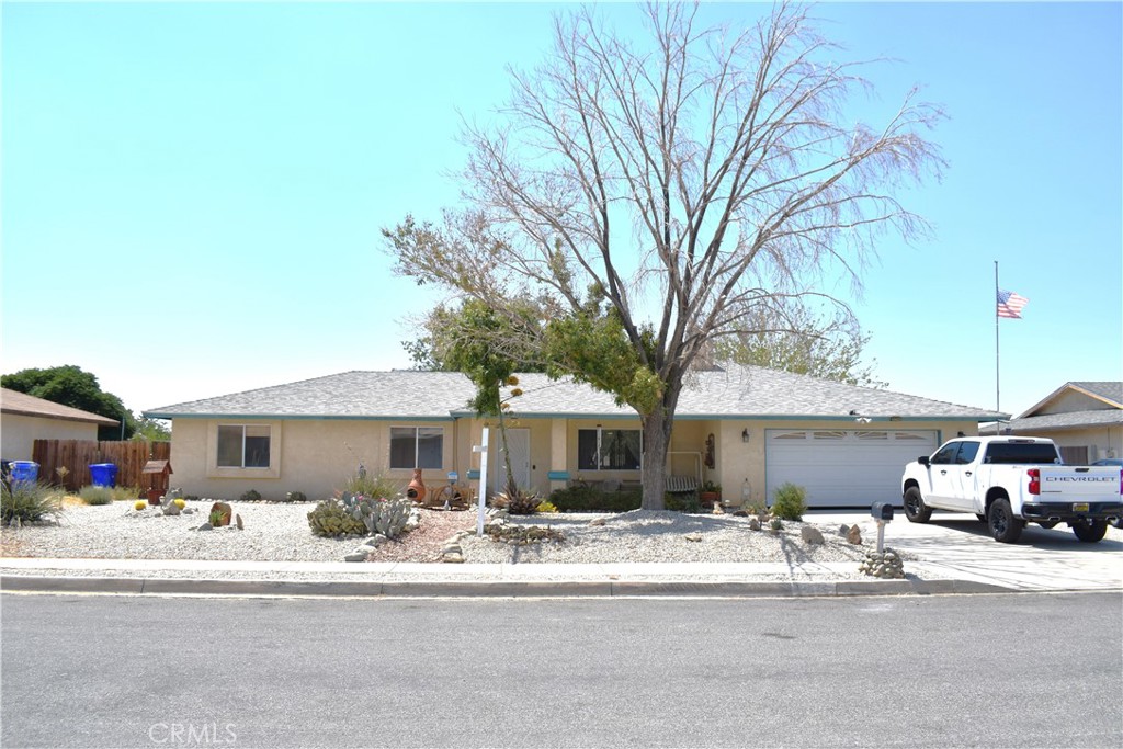 SUPER NICE 4/2 HOME WITH A SPLIT FLOOR PLAN IN APPLE VALLEY - PRIME LOCATION NEAR VANGUARD PREP SCHOOL! NEW ROOF, NEW FLOORING AND NEW KITCHEN COUNTERS ALONG WITH RV ACCESS AND A HUGE YARD!! Nestled in a prime location near the renowned Vanguard Prep School, this property boasts pride of ownership. As you approach the home, you’ll be greeted by a charming covered front porch that is perfect for sipping your morning coffee on. Step inside and be amazed by the spacious rooms and thoughtful split-floor plan, providing the perfect blend of comfort and privacy. The large primary bedroom is tucked away on one side of the home, ensuring your personal retreat from the rest of the house. All of the additional bedrooms are generously sized. Enjoy cozy evenings by the fireplace in the front room, creating a welcoming atmosphere. The kitchen opens up to the dining area, making it perfect for entertaining or gatherings. The large backyard has wonderful mature trees that offer the perfect amount of shade along with a large patio that is perfect for entertaining. (Above ground pool does not stay). The front and rear yards feature mostly desertscape for easy maintenance. Mature trees provide shade and add to the overall charm of the home. For privacy, the backyard is surrounded by fencing. RV parking is available on the side of the home for added convenience and there is tons of room for toys!. Buyer to verify all information.