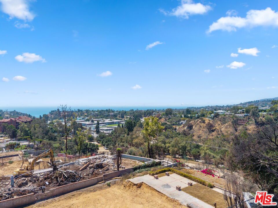 Incredible opportunity to design and build your dream home close to the village, parks, and local shops with expansive ocean, mountain, and canyon views from all directions. The previous home sat on a quiet street and invited natural light from every direction. The home backs up onto Temescal Park. The debris removal by the Army Corps of Engineers has been completed, as well as private clearance. The prior structure was a 4400 square foot home, including 4 bedrooms and 4 bathrooms. It was meticulously custom-designed by the current owner. This lot provides easy access to the Palisades Village as well as hiking trails.