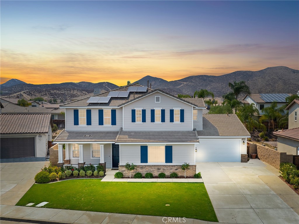 Discover this magnificent Heritage Lakes estate nestled in a peaceful cul-de-sac, featuring over 3,800 square feet of luxurious living space on an expansive 11,000+ square foot lot with charming curb appeal and paid-off solar panels. This stunning 5-bedroom, 3.5-bathroom home showcases an office with custom built-ins, formal living room with soaring ceilings, elegant formal dining room with wine cooler built-ins and wainscoting, and a welcoming family room centered around a beautiful brick and wood fireplace with built-in storage. The heart of the home is the spectacular kitchen, boasting a massive island perfect for culinary enthusiasts, double ovens, built-in microwave, stainless steel hood, and professional cooktop. A convenient downstairs bedroom ensuite provides perfect in-law quarters or guest accommodations. Throughout the home, abundant natural light flows through spaces enhanced by dramatic high ceilings and thoughtful storage solutions, including a giant under-stairs closet and an exceptional upstairs laundry room with Pottery Barn organization systems and utility sink. The luxurious master suite features dual walk-in closets and a spa-inspired bathroom, while three oversized secondary bedrooms provide ample space for family or guests. The private backyard is truly extraordinary, featuring authentic Temecula vineyard vines from one of the region's oldest original vineyards, a cozy fire pit, tranquil water fountain, and productive fruit trees including almond, lemon, donut peach, and apple varieties. Practical amenities include a spacious 4-car garage with additional washer/dryer hookups, EV charging station, and a reverse osmosis system. Heritage Lakes community amenities elevate the lifestyle with a pristine 25-acre lake offering paddle boating and catch-and-release fishing, two Junior Olympic swimming pools, splash park, wading pool, clubhouse, scenic walking trails, multiple playgrounds, and tennis and pickleball courts.