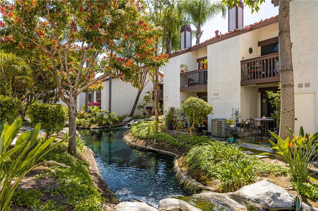 Escape to your own paradise in tropical Placentia Lakes! Welcome to this serene and stylish 2-bedroom, 2.5-bath townhome in the heart of the exquisitely landscaped Placentia Lakes community, where the lush surroundings and peaceful streams bring serious Hawaii vibes. With 1,300 sq ft of thoughtfully designed living space across two levels, this pristine home offers the perfect blend of comfort, charm, and low-maintenance living. Step inside to an open, flowing floor plan featuring beautiful upgraded LVP flooring and a stunning remodeled kitchen that opens effortlessly into the dining and living areas - ideal for entertaining and functional living. Both spacious bedrooms and full bathrooms are upstairs, while a convenient half bath serves the downstairs. Enjoy not one, but two private patios - one on each level - where you can take in views of the lush landscaping and unwind to the tranquil sound of the community stream. Additional highlights include a fully upgraded master bath, one-car garage with extra storage, and two additional parking spaces. This home offers an incredible opportunity for first-time buyers or anyone seeking an easy-care lifestyle in a centrally located, resort-style community. Don't miss your chance - this gem absolutely won't last long!