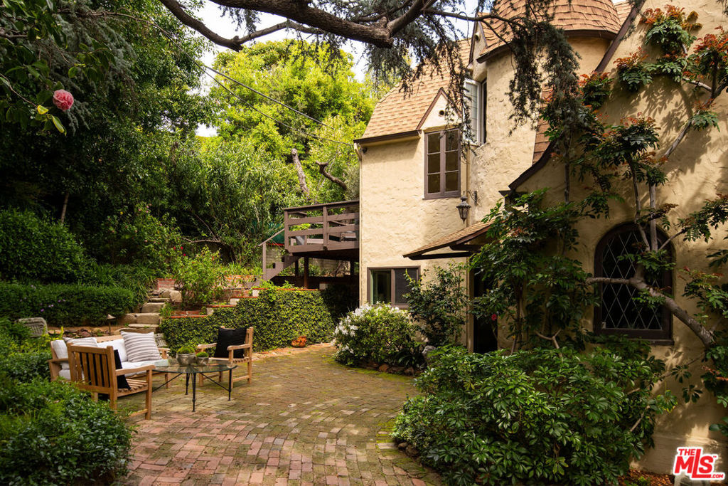 "Hilldale House", a magical estate encompassing TWO PRIVATE SINGLE-FAMILY HOMES PLUS GUEST HOUSE nestled amongst mature old growth landscaping in this most sought-after Bird Street adjacent enclave. (1) 1232 HILLDALE AVE: an enchanting 1924 turreted Cottage, secluded behind gates amidst magnificent grounds with an English garden that recollects the Devonshire countryside, yet just steps to the beating heart of the Sunset Strip. Included is an incomparably charming three-story guest house "The Carriage House" that adds a whimsical aura to this storybook property. The entire home exudes old world class and is adorned with vintage period finishes that transport back to the golden age of Hollywood. With 100 years of history, this residence continues to inspire romance, creativity and tranquility; (2) OZETA HOUSE: a 3 Bed/2.5 Bath spacious two-story home, completely independent and private from the main residence. Surrounded by a forest of trees and singing birds, this 2nd home is a time capsule to the nostalgic 1970's and features an enormous beamed Great Room, large backyard deck and a private garden. The entire property is sited on a huge corner lot perched perfectly above Sunset Blvd with views of the city below. 8 parking spaces total, each home enjoys 4 separate spaces. APPROVED RTI PERMITS AND PLANS for an extensive transformation and expansion to elevate this already legendary property - maintaining and enhancing the historic charm while adding every imaginable modern luxury. This unique offering presents a potentially generational opportunity with multiple use options for an owner user, investor or developer.