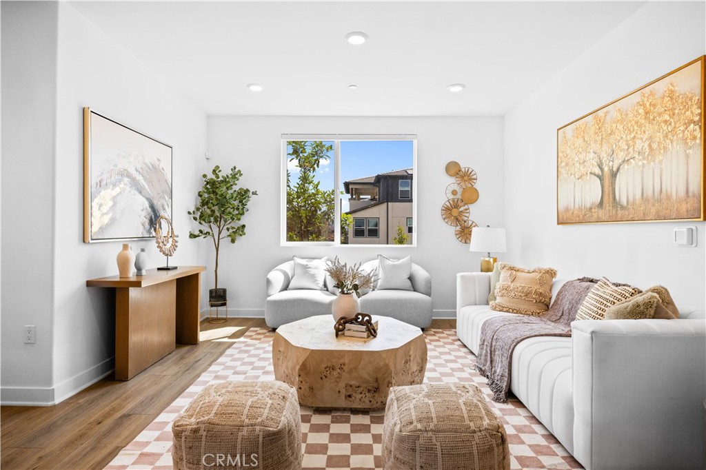 Discover upscale living in this beautifully designed 3-bedroom, 2-bath residence in Anaheim’s Platinum Triangle, just minutes from Disneyland, Angel Stadium, and the Honda Center.This spacious 1,698 sq. ft. end-unit flat is quietly positioned on the second floor of a gated building with secure entry and elevator access. Enjoy an open-concept floor plan filled with natural light, highlighted by a modern kitchen with white shaker cabinets, granite counters, and stainless steel appliances. The great room flows seamlessly to a private balcony with serene park views. The primary suite offers a dual vanity, step-in glass shower, and walk-in closet. Additional features include in-unit laundry with washer & dryer, and a private enclosed 2-car garage with convenient hallway/elevator access.Community amenities include a pool, spa, BBQ area, tot lot, and park-like grounds. Perfect blend of comfort, convenience, and modern style in a prime location.