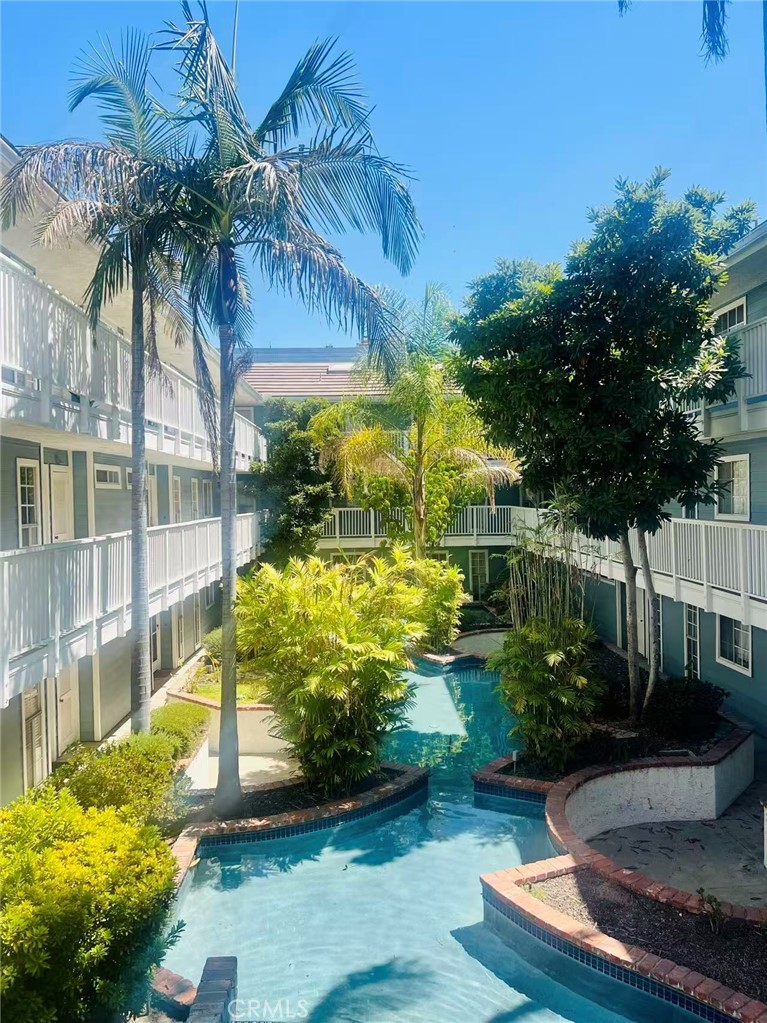 This Oasis condo will make you feel like you're on Hawaii, peaceful, tree-lined neighborhood near Madison Heights and the Playhouse District in Pasadena. Walking distance to cafe shops, Macy and Trader Joe's. Two blocks from Urth Cafe. This second floor unit is conveniently close to the elevator. As you step inside there is a cute little bar, the open floor plan immediately welcomes you with a bright and airy ambiance. To the left is the dining area provides a warm gathering space, and beyond it is the kitchen with windows overlooking the front hallway of the building and palm trees with blue sky. Flowing through from the dining area into the living room features high ceilings. Gorgeous big red brick fireplace and a large sliding glass window door leading to a spacious private balcony. To the right of the living room is a laundry room with double deck washer and dryer tucked away in a closet for convenience. The first bedroom is complete with two wall closets, providing plenty of storage, there is a bathroom diagonally to bedroom. The Left side of the condo is the Master bedroom with bath, it also has two closets with sliding doors lots of storage space. This home includes subterranean one parking with one small storage unit in front parking space.