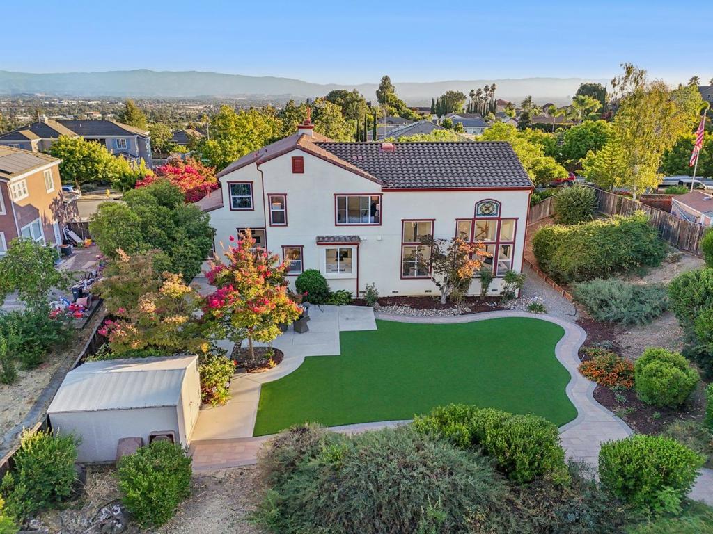 Nestled in the scenic East Foothills of San Jose, this impressive 3,514 sq. ft. residence offers 6 bedrooms, 4 bathrooms, and sits on an expansive 23,000 sq. ft. lot, perfect for both grand entertaining and everyday living. Step inside to discover new French oak hardwood flooring, soaring ceilings, and abundant natural light. The updated kitchen boasts stone countertops, refinished cabinets, new fixtures, and a stylish, functional layout. Bathrooms shine with new vanity tops, shower doors, and modern fixtures, while fresh interior paint creates a move-in ready feel. The luxurious primary suite features a double vanity, separate shower and soaking tub, large walk-in closet, and dedicated makeup desk. In the living room, a custom built-in entertainment wall with LED fireplace and mood lighting sets the tone for cozy evenings. Outdoors, the huge backyard is a private oasis with lush mature trees, low-maintenance astro turf lawn, a dedicated play area, and a garden tool shed. With ample space for gatherings, gardening, or future expansion, this home offers a rare combination of size, style, and locationjust minutes from parks, trails, and city conveniences.