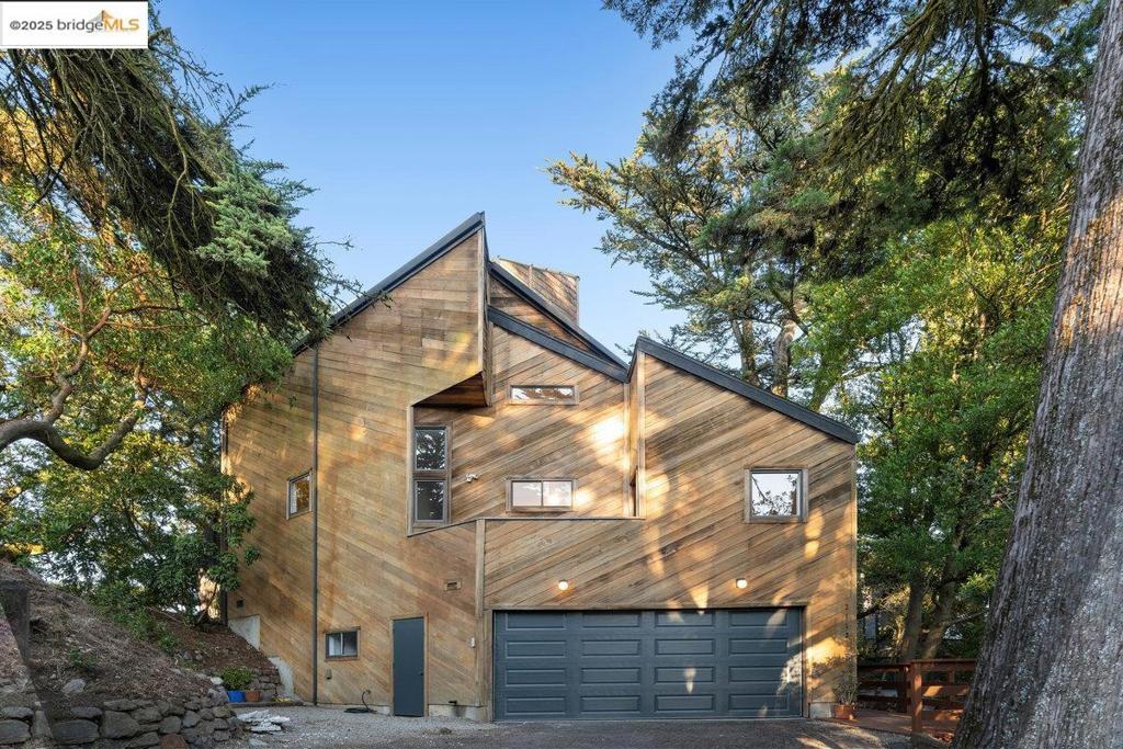 Breathtaking Mt. Diablo views, an expansive backyard oasis, and a stunning architectural design—welcome to 2112 Manzanita Drive in Oakland’s Montclair. This 2,260 sq ft architectural gem offers 3 spacious bedrooms, a versatile den/office, and 2 beautifully renovated bathrooms. Light pours through skylights and large windows into the open-concept living space, creating a bright and inviting atmosphere. The living area flows seamlessly to a large patio and private yard, perfect for outdoor dining, entertaining, or quiet relaxation while soaking in panoramic views. The newly renovated chef’s kitchen is a showstopper, featuring a large island, sleek finishes, modern appliances, and abundant counter space for cooking and hosting. Upstairs, a cozy family room with a fireplace offers the ideal spot to gather or unwind. Combining modern elegance with the beauty of nature, this home delivers a rare blend of comfort, style, and indoor-outdoor living—all just minutes to Montclair Village, top schools, & Bay Area commutes and a short walk to The Hills Swim & Tennis Club.