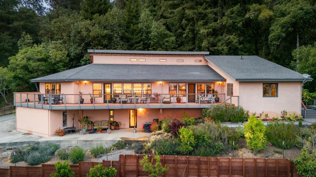 End-of-the-road privacy: immersed in nature, steeped in silence, set among the redwoods, with sweeping views across the orchards and fields of Corralitos all the way to Monterey Bay. This spacious 3+br, 2 ba, 2974sf home with open kitchen, has soaring ceilings and light-filled interiors. In addition to the three bedrooms, the house has a second living room, a large loft/meditation room, a gym/library, and a free-standing, hillside office/writers studio. Easy, casual flow, great separation & two expansive decks (front and side) for indoor/outdoor living. Recently updated with contemporary amenities including high-end remodeled kitchen with marble counters/backsplashes, pantry, custom wood cabinets & 6-burner Wolff range. Wide-plank wood floors, skylights, French doors & sequestered outdoor spa & firepit. Minutes to famed Corralitos Market & wine tasting. Next-door to 400-acre preserve with hiking trails. This remarkable 12.5-acre property, only an hour south of Silicon Valley, isnt just a beautiful retreat, its a creative sanctuary.