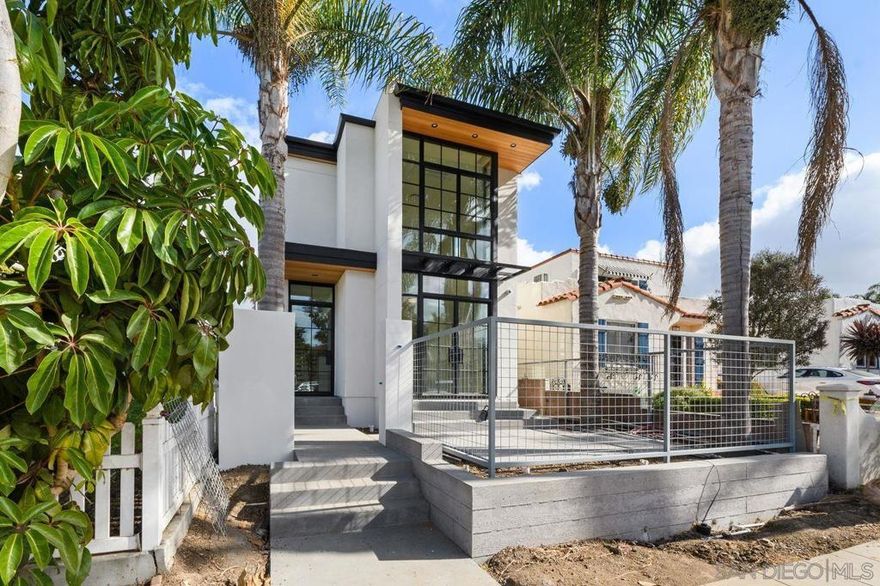 This stunning custom newly built property is located in the heart of La Jolla Village, offering 3 ensuite bedrooms, 1 optional bedroom, 4 baths and a 2-car carport. Experience modern architectural design with an open concept layout, the home is an impressive and property that boosts exceptional design, materials and craftsmanship.  The interior offers a sophisticated design with attention to detail and designer high-end finishes, such as extravagant maple hardwood flooring a  a gourmet chef’s kitchen featuring exquisite quartz countertops, a dacor stove, two ovens, and custom maple cabinetry, The great room includes one of 2 fireplaces, creating a cozy and inviting atmosphere. Home includes a separate laundry room with washer and dryer.   The outdoor patio includes a hot tub and bar area, ideal for relaxation and entertaining. Step outside onto the oversized deck where you can enjoy ocean views at sunrise or sunset. This home is a welcome retreat for those seeking both luxury, walkability and the La Jolla Village lifestyle!