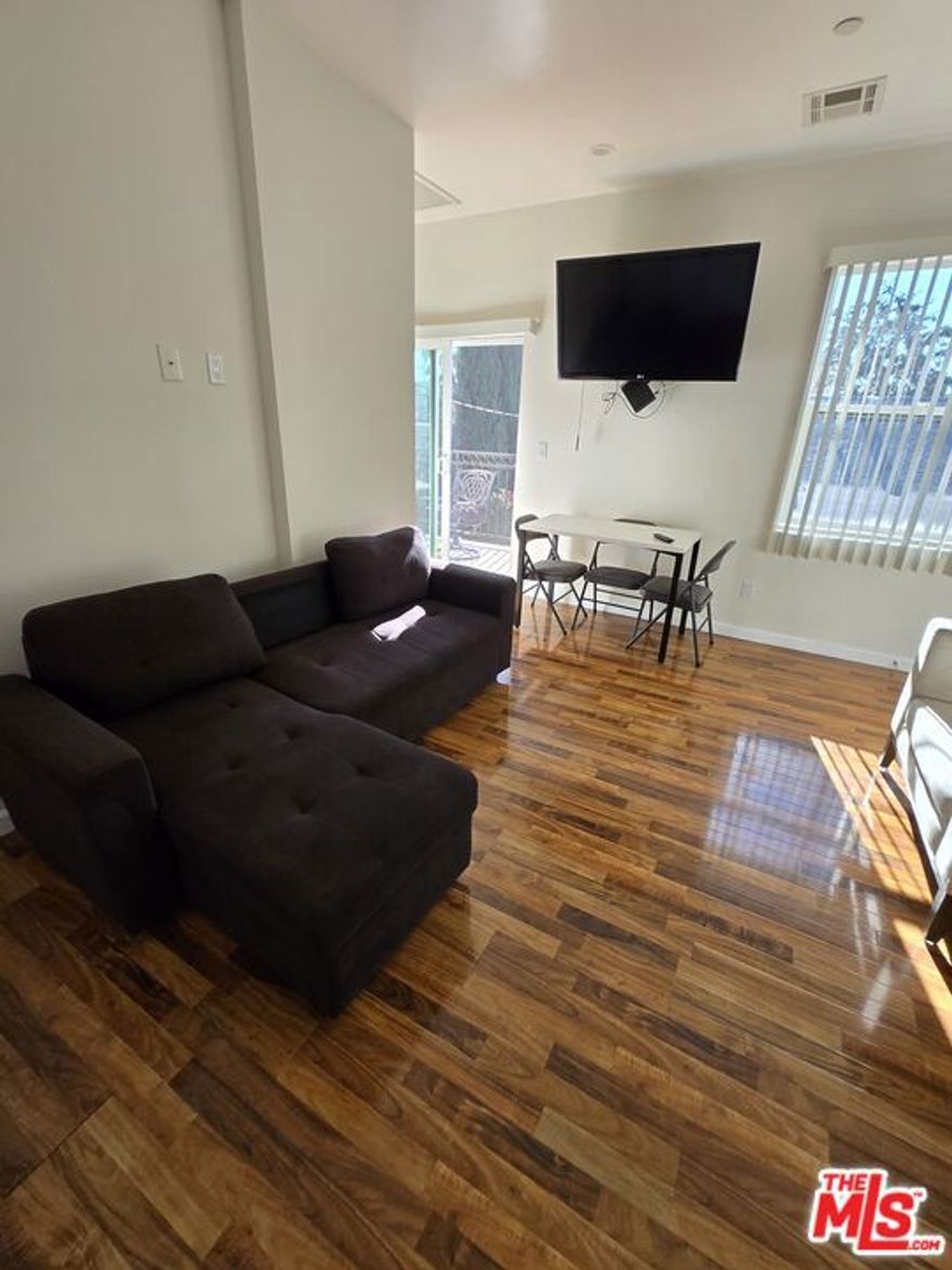 Newly constructed one-bedroom, one-bathroom apartment for rent in Glendale, located on the second floor. The unit features a spacious balcony with a pleasant view, high ceilings, and recessed lighting throughout. It comes equipped with a side-by-side refrigerator, stove, and television. Central air conditioning and heating are included. An in-unit washer and dryer provides added convenience. The apartment offers approximately 575 square feet of living space and includes a large wall-to-wall closet.