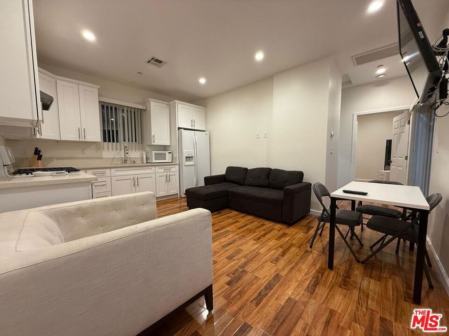 Newly constructed one-bedroom, one-bathroom apartment for rent in Glendale, located on the second floor. The unit features a spacious balcony with a pleasant view, high ceilings, and recessed lighting throughout. It comes equipped with a side-by-side refrigerator, stove, and television. Central air conditioning and heating are included. An in-unit washer and dryer provides added convenience. The apartment offers approximately 575 square feet of living space and includes a large wall-to-wall closet.