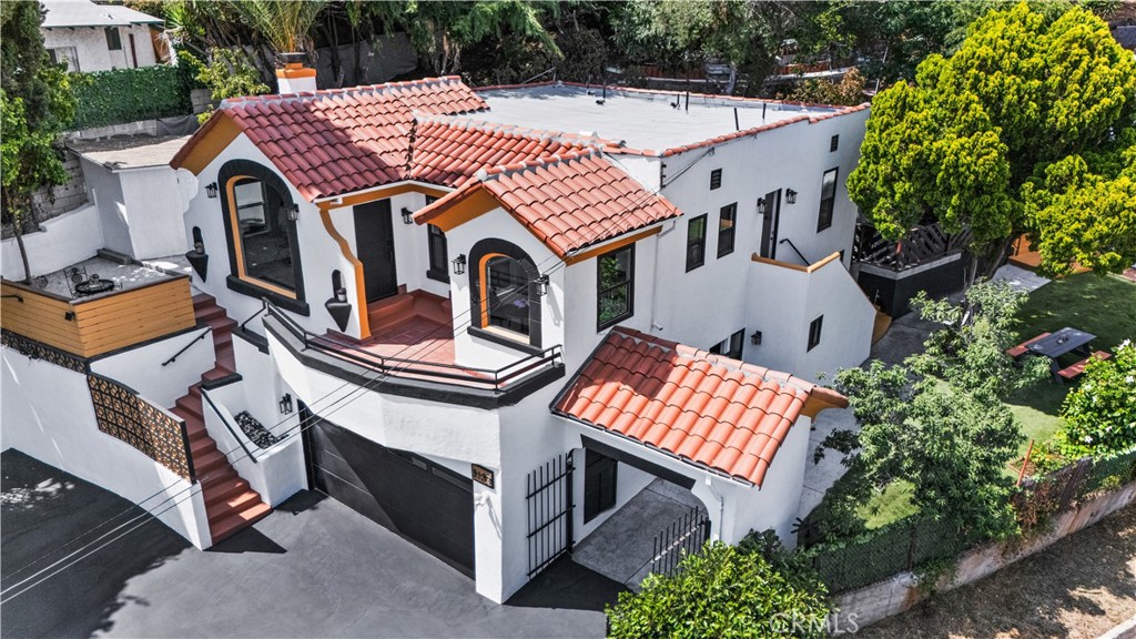 A one of kind Urban Oasis in Lincoln Heights | Compound with 2 separate homes
Perched on a serene 1/2 acre lot and tucked into the rolling hills , this extraordinary property offers a rare opportunity to own a multi-home retreat with layered, terraced grounds and sweeping views that reach the Pacific Ocean and Catalina Island on clear days, this is more than just a home—it’s a lifestyle sanctuary.
Both Spanish-style residences have been thoughtfully and meticulously renovated from the inside out, blending old-world with new modern charm. Unique details to the architecture of the Main house allow you to find beauty in the high vaulted arch ceilings with plenty of natural light, restored original red oak floors, also the chimney's original tile has been preserved. The kitchen offers an open floor plan for entertaining plus a breakfast nook with a window view of the city. Black calacatta countertops, Spanish brick backsplash tile, white shaker cabinetry, recessed lighting throughout, the remodeled bath's exudes timeless sophistication, Central A/C and Heating ,EV-ready 200 AMP. 2 car garage leads to downstairs office plus flex room—perfect for working from home or creative pursuits.
Each home includes its own dedicated laundry room, dual-pane windows, tankless water heaters, and updated electrical panels, ensuring both comfort and sustainability.
The back house offers stylish LVP flooring, efficient mini-split HVAC systems, a private yard and patio, and a versatile downstairs bonus room—ideal for guests, a studio, or a home gym.Last but not least you will find a she shed on the hill with privacy and views.
The grounds are where this property truly shines. Multiple tiered levels create distinct zones of exploration and tranquility with mother nature — perfect for gardening, beekeeping, raising chickens or even baby goats. Children will delight in the natural play spaces, while adults can enjoy shaded garden parties, relaxed book club gatherings, or outdoor movie nights under the stars. Towering mature trees and vibrant native plants at the heart of the compound allow you to find peace captured in your courtyard with a fountain that gives you just the right energy.
A truly unique offering in one of LA’s most historic neighborhoods—where city convenience meets hillside serenity. Whether you’re seeking multi-generational living, rental income, or your own personal retreat hidden from the city but so close.