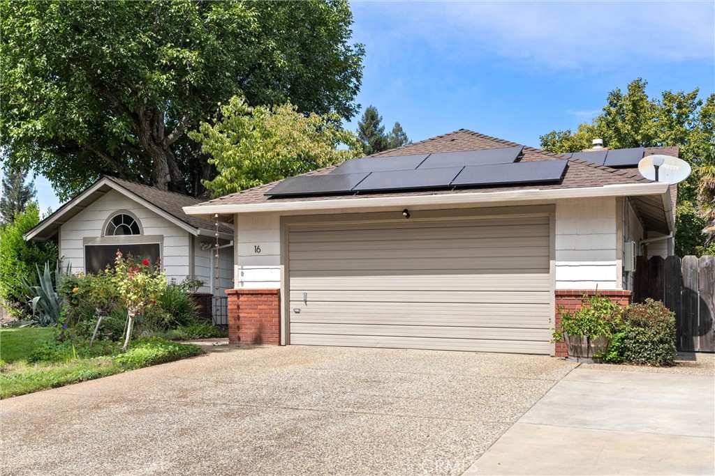 Welcome to 16 Dahlia Way, where comfort, style, and thoughtful design come together in Chico’s sought-after Holly Gardens subdivision. Tucked at the end of a peaceful cul-de-sac, this 3-bedroom, 2-bathroom, 1,842 sq. ft. home offers the perfect blend of retreat and convenience, just minutes from the West Avenues, Chico State, downtown, and the iconic Esplanade. From the moment you arrive, the curb appeal and lush landscaping set the tone. OWNED SOLAR keeps energy costs low, while UV film on the windows lets natural light flood the home without the glare or heat, keeping the spaces cool and comfortable through every season. Step inside, and you’re greeted by soaring 20-foot vaulted ceilings and an open, airy floor plan that invites you to stay awhile. Two living spaces create flexibility for gatherings, quiet reading, or game nights by the gas fireplace. The dining areas give everyone a seat at the table, whether it’s a casual breakfast or a full holiday dinner. The kitchen is tucked thoughtfully away, creating a functional space for cooking with tile counters, recessed lighting, a skylight, and plenty of cabinetry for storage. It’s perfectly positioned so you can prepare meals without being in the center of the main living space—ideal for those who value both connection and separation. This single-story home features a split floor plan, with the primary suite and laundry room thoughtfully situated on one side of the home for added privacy. The primary suite is a true retreat with vaulted ceilings, dual closets (one in the bedroom and one in the bathroom), and a beautifully appointed ensuite with dual sinks, a soaking tub, a walk-in shower, and luxurious heated tile floors that make every morning feel like a spa experience. On the opposite side of the home, you’ll find two comfortable guest bedrooms, including one with a Murphy bed that easily transitions from a home office to a welcoming guest room. The hall bath offers a skylight, a separate vanity, and plenty of storage. The backyard is a private sanctuary with lush landscaping and multiple areas for relaxing and entertaining. Imagine mornings on the covered porch swing, evening dinners on the raised deck, and gatherings under the trees with friends and family. Additional highlights include a new HVAC system, automatic sprinklers, and abundant storage throughout. At 16 Dahlia Way, every detail invites you to slow down, unwind, and enjoy the best of Chico living.