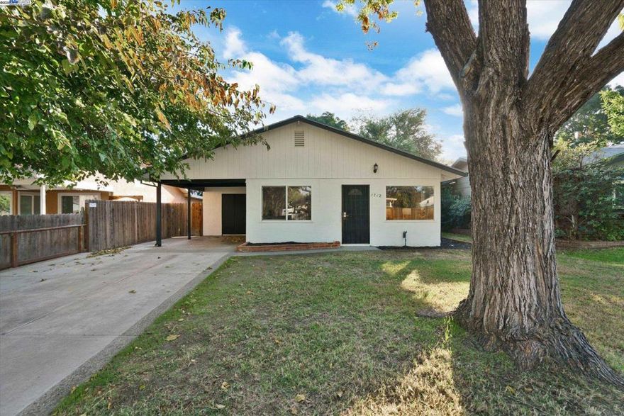 Don't miss the Crown Jewel of Central Tracy! 1712 East Street is a charming single-story rancher that has been beautifully remodeled from top to bottom! The brand-new kitchen showcases custom cabinetry, sleek quartz counters, and stainless steel appliances, along with a cozy eat-in dining area. The home features fresh interior and exterior paint, handsome luxury vinyl plank flooring, stylish new light fixtures, and an updated bathroom with a modern vanity. Set on a generous lot with endless possibilities — including potential for an ADU — this property offers both comfort and flexibility. Located near Sutter Hospital, just a short stroll to Lincoln Park, Tracy High, and Central Elementary, and only one mile from downtown Tracy’s charming shops, restaurants, weekly farmers market, annual wine stroll, and festive parades. Come experience modern upgrades, small-town charm, and an ideal Central Tracy location all in one!
