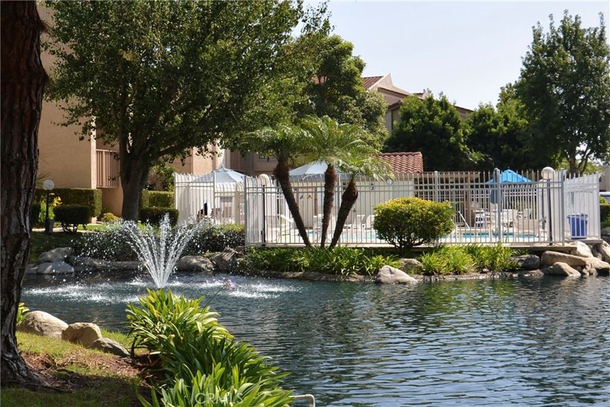 Resort-style living in one of Harbour Vista’s premier view locations! Move in condition upper-level 2 bed, 2 bath condo with elevator access.  Enjoy amazing views of the sunsets, a beautiful fountain and pool from your private balcony! The grounds are landscaped with peaceful ponds, tranquil streams and bridges throughout.  Walk into an open floor plan with soaring vaulted ceilings, a spacious living room, laminate wood floors, a cozy fireplace and an abundance of natural light. Two primary bedrooms with en suite baths—one with vaulted ceilings, double door entry, new quartz dual sink counter top, walk-in closet and an additional patio door with access to the private balcony.  The other bedroom features an en suite bath, mirrored closet doors and new quartz counter top.  Newly updated kitchen boasts new quartz counter tops and backsplash and includes a gas range/oven, microwave, dishwasher, and ample cabinet storage.  For your convenience there is inside laundry, a detached 1-car garage, storage and an assigned parking space.  This community offers incredible amenities include 2 pools/spas, clubhouse, sports court, dog park, BBQ area and lush landscaped grounds. HOA covers water, trash, exterior maintenance and amenities.  Minutes to the beach, Bella Terra Mall, Bolsa Chica Wetlands, Huntington Bay, dining, Trader Joe’s and freeways. Gated community. Experience Coastal-Living at its Best!