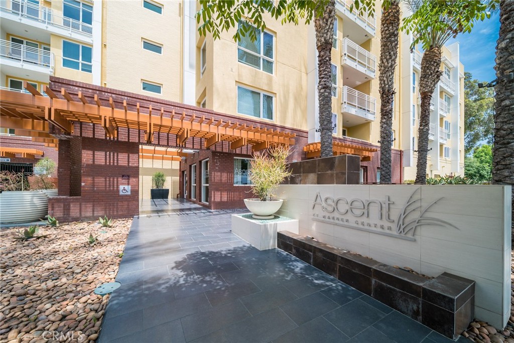 FHA and VA Approved. The ASCENT at Warner Center a luxurious, modern building completed in 2010! This rare 2-bedroom, 2-bathroom unit offers ultimate privacy and is situated in one of the quietest locations within the community close to the elevator. This home features the highly sought-after “Plan B” layout, the most desirable floor plan in the complex with an open-concept design, kitchen island, and bedrooms located on opposite sides for maximum privacy. As you enter, you’ll appreciate the smart layout and generous storage throughout. The inviting living room boasts elegant wood flooring and a large floor to ceiling window that floods the space with natural light and opens onto a private balcony perfect for relaxing or entertaining. The spacious primary bedroom includes a walk-in closet, a large en-suite bathroom, and oversized windows bringing in even more natural light. The second bedroom is conveniently located next to a full bathroom, ideal for guests or family. Additional features include an in-unit washer and dryer, ample storage, two assigned tandem parking spaces in a gated covered garage, two side by side storage next to the parking spaces, on-site guest parking, high-speed EV charging stations, and secure package delivery lockers. THE ASCENT offers resort style amenities including a pool, spa, cabanas, fitness center, clubhouse with kitchen, game room, entertainment lounge with flat screen TVs, outdoor BBQ areas, cozy fireplaces, and a dog park. Now is the perfect time to invest in the heart of Warner Center home to the LA Rams and exciting future developments. Enjoy being just a short walk from The Village, Westfield Topanga Mall, Warner Center Park, the Rams’ Training Facility, and the highly anticipated "LA Warner Center" development. Experience luxury living at its finest! Parking spaces #50