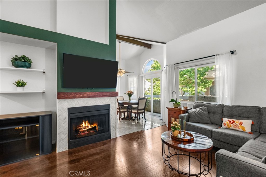 Live the good life in this beautifully upgraded 3-bedroom, 2-bath + spacious loft upper-level corner-unit condo in the highly sought-after gated community of Sierra Glen! From the moment you walk in, you're welcomed by soaring vaulted ceilings, brown-painted exposed wood beams, and abundant natural light that fills the open and airy layout. The home features premium hardwood-like flooring throughout the main living areas and all bedrooms, creating a clean, cohesive, and modern feel.
Enjoy a cozy fireplace with a gorgeous stone wall surround, a stylish stone accent wall along the staircase, and a versatile loft perfect for a home office, guest room, or creative space. The kitchen and bathrooms feature elegant tile flooring for durability and style. The primary bedroom features a walk-in closet and direct access to a full bathroom, while two additional bedrooms and a second full bathroom offer comfort and flexibility.
Relax on your private patio with peaceful city lights and community views, and take advantage of your rare side-by-side 2-car garage with extra storage. The VA-approved Sierra Glen community includes a pool and spa, and is ideally located near the 14 Fwy, shops, gyms, dining, and top-rated schools. This home truly has it all—space, upgrades, location, and charm. Don’t miss your chance to make it yours!