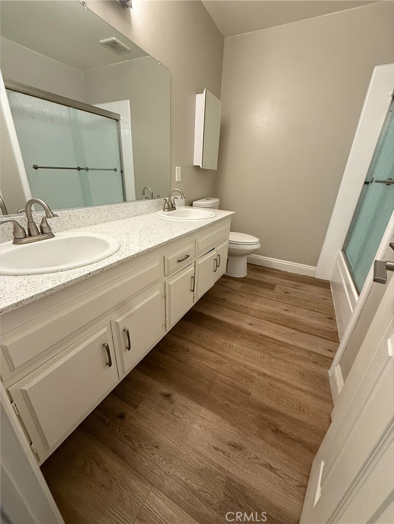 Welcome to this charming 2 bedroom, 1 bathroom apartment offering a spacious layout with modern touches throughout. Enjoy hardwood-style flooring, a walk-in closet, and a stylish double-sink vanity. The unit includes central A/C and heating for year-round comfort. Step outside to your private front porch, perfect for relaxing. Onsite amenities include convenient laundry facilities, assigned parking, and access to a community pool.