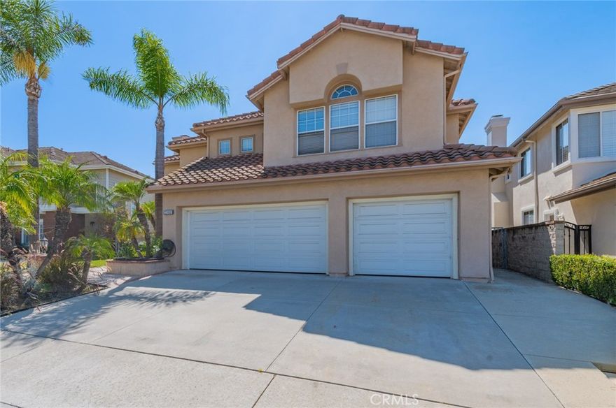 Beautiful pool home, perfectly situated on a peaceful cul-de-sac street. This spacious five-bedroom, 3.5-bath residence features a convenient main-floor bedroom with a private ensuite for guests or multi-generational living. The soaring volume ceilings and a cozy fireplace in the large living room create an impressive, yet welcoming, first impression. Entertain with ease in the formal dining room, complete with elegant French doors, or gather in the lovely kitchen, which showcases granite countertops and a built-in refrigerator. The adjacent breakfast nook flows seamlessly into the family room, where a second fireplace adds a touch of warmth. Upstairs, a luxurious master suite awaits with a tranquil fireplace and a generous walk-in closet. The backyard is a private oasis, featuring a glistening pool, a relaxing spa, and a built-in BBQ island, all complemented by a lovely view. Recently updated bathrooms and fresh paint throughout add a modern, move-in-ready appeal.