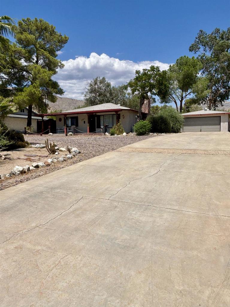 Welcome to 49260 Mojave Dr. in Morongo Valley. This quaint 2 bedroom, 2 bath home boasts close to 1400 sqft of living space and is situated on just under a half acre flat usable lot. Fully fenced yard with many mature shade trees. The oversized detached 2 car garage offers washer & dryer hookups along with its own toilet and shower making it very possible to convert this space to detached, income producing ADU. Ample parking and storage space, large wrap around driveway for added convenience. Private rural setting with beautiful mountain views to the South West. Only minutes to Joshua Tree and downtown Palm Springs! Easy access to the 10 freeway, this home is perfect for the first time home buyer or even someone whos is looking for a quiet neighborhood conveniently located close to all.
