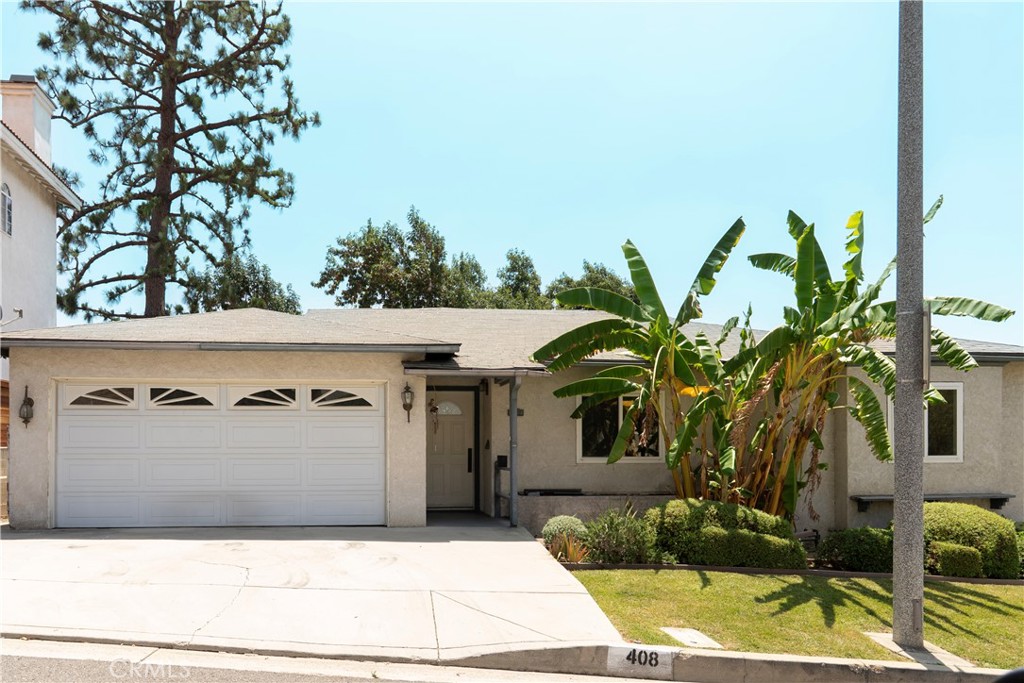 Welcome to 408 De La Fuente -- Your Monterey Park Hideaway!
Tucked away on a tranquil hillside street, this charming single-family gem proves that good things really do come in perfectly-sized packages. With 3 bedrooms, 2 bathrooms, and approximately 1,830 square feet of thoughtfully designed living space, this home strikes that sweet spot between cozy and spacious. Step inside to discover original hardwood floors that have more character than the latest Avengers Movies. Three comfortable bedrooms and two full bathrooms provide the perfect setup for family life, roommate harmony, or that guest room you've been promising your in-laws. The bonus flex room is your blank canvas – home office by day, yoga studio by evening, or fort-building headquarters on weekends. The traditional kitchen boasts generous cabinet space (because we all know you can never have enough storage) and vintage charm that would make your grandmother proud. This home sits on a substantial ~7,397 square foot lot with a fenced backyard that's perfect for everything from weekend BBQs to letting your four-legged family members rule their kingdom. The elevated back patio offers neighborhood views that are perfect for your morning coffee contemplation or evening wine wind-down. A 2-car width garage plus a spacious driveway that actually fits two cars without playing vehicular Tetris. Nestled in Monterey Park's coveted hills, you're close enough to civilization to grab groceries and hit the freeway (10, 710, 60 & 5 access!), but far enough removed to actually hear birds instead of traffic. Served by the highly-coveted Alhambra Unified School District (Brightwood & Mark Keppel) this spot checks all the boxes for families, professionals, or anyone who appreciates the art of strategic location. This isn't just a house – it's your next chapter waiting to unfold. Move-in ready and brimming with potential, it's perfect for couples ready to nest, roommates seeking space and style, or families wanting room to grow. Sometimes the best things in life come with hardwood floors and hillside views. Schedule your showing today!