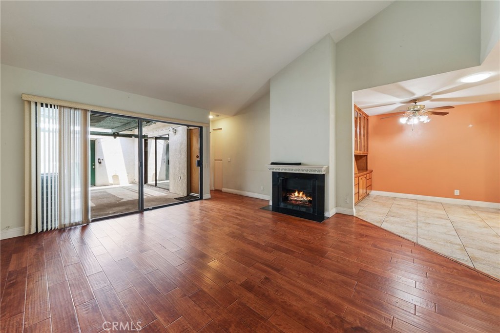 Best priced single level condo in La Habra AND it has a two car garage. You'll love the layout with the patio connecting the house to the garage. Pull in your garage and when you close the door it's all you. From the front door you'll see a nice open entryway that leads to the dining room and living room. The dining room has built-in shelves, cabinets, and a desk area. The kitchen is spacious and has a window to the front of the unit looking out at the lush green grass. There is lots of counter space and storage for all your kitchen essentials. The living room has vaulted ceilings and a big sliding glass door that looks out to your private patio. You'll enjoy the central air-conditioning on these hot summer days and when it cools off you can cozy up on the couch and enjoy the gas fireplace. The primary bedroom has natural light coming in from its own sliding glass door. The attached primary bathroom has an easy to access shower and a generous walk-in closet with lots of shelving and hanging space. While the primary bedroom is in the back of the unit, there is a second bedroom and bathroom in the front of the unit. The second bedroom has vaulted ceilings and a wall-length closet. This bedroom faces East and gets plenty of natural light from two windows. No community laundry here, you have your own laundry hooks up are in the garage, and you can still park two cars with storage.