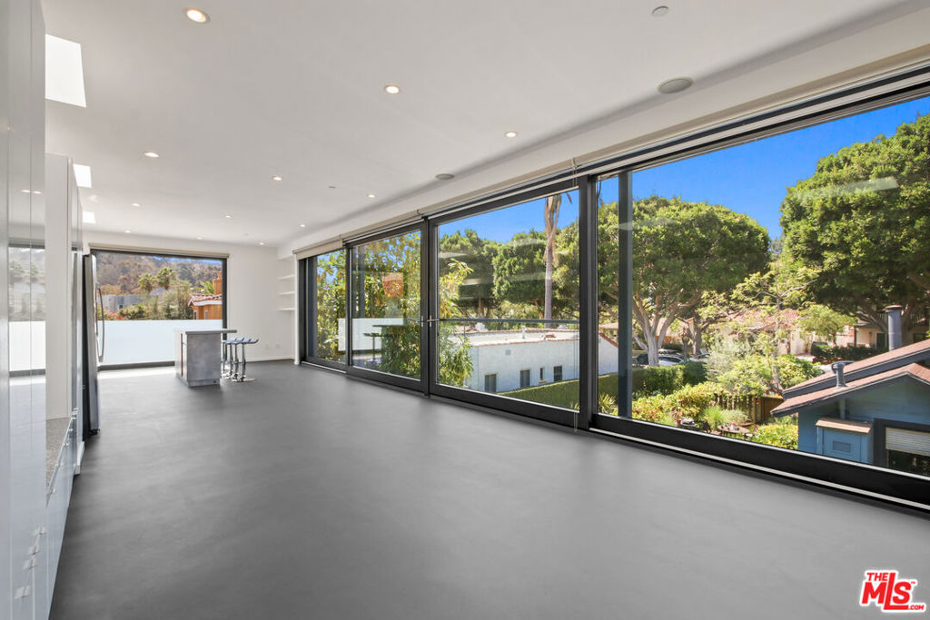 This striking modern residence was crafted by renowned architect Roger Kurath of Design 21 and showcased in DWELL Magazine. It features an expansive, open-concept living, dining, and kitchen space framed by over 40 feet of floor-to-ceiling, sliding glassblurring the line between indoors and out. Three spacious bedrooms and two full baths include a serene primary suite with a two-person soaking tub. Soaring ceilings, polished concrete floors, imported dual-pane windows highlight the home's thoughtful sustainability and sleek style. Outside features a fully enclosed private backyard with space for barbecuing and entertaining, surrounded by native California landscaping. Nestled at the quiet cul-de-sac end of a tree-lined street, the home is just moments from downtown Culver City, Sony Studios, the Culver Steps, Erewhon, Equinox, and more.