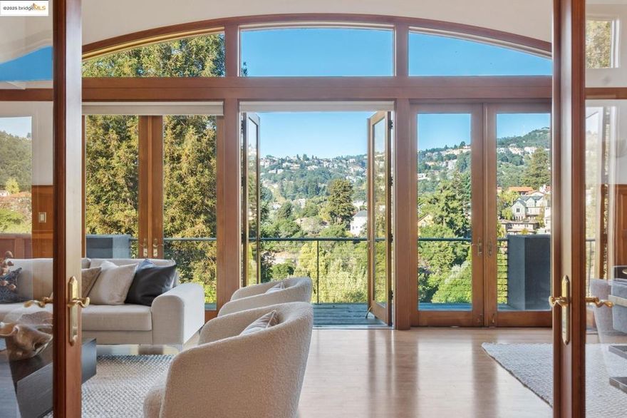 Dramatic modern home, defined by its bold geometry and contrasting wood and stucco facade. An elevator navigates between its three levels. A striking grand living-dining room spans the length of the home, and opens to a long back deck and vistas across the hills. Large kitchen with electric range and wet bar. A versatile den and one converted garage bay are adjacent for home office or studio. Upstairs a long mezzanine looks down on the main public rooms, leading to the primary suite with private office and walk-in closet. The primary bath offers curbless roll-in shower. On this level are a second bedroom with balcony, full bath, laundry room and storage. The lower floor features a family room with access to the lower patio and backyard. A bedroom and bath are configured for separated living with a private entrance. This adaptable, multi-level layout and abundant indoor-outdoor space offer enormous flexibility in Oakland's premier neighborhood. OPEN THURSDAY, OCT 9, FROM 10:00AM-1:00PM.