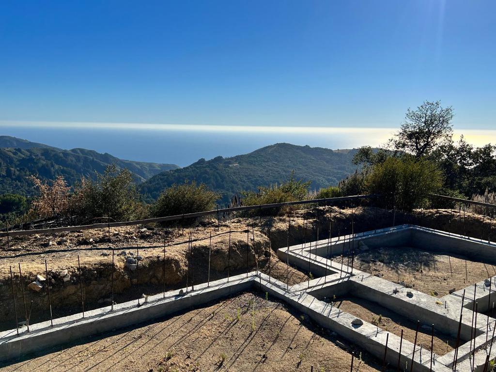Set upon an ocean view forested ridge, the foundation is in place for a new ultra-modern home, designed and manufactured by Stillwater Dwellings. It is ready to be shipped and assembled on-site. County permits are current. Water and septic are already developed and the property is ready to build your off-grid Big Sur dream home. Just over 2 miles from Hwy 1, and less than 30 minutes to Carmel, this 5 acre parcel is in the Green Ridge community very close to the Mid Coast Fire Station. The property is accessed via paved County Palo Colorado Road, then up the private Greenridge gravel road. The expertly crafted 875 sq ft. pre-fabricated home is sustainably designed with a distinctive sense of place in tune to sit perfectly within the wooded knoll location.The 5 secluded acres have oak trees, stately madrone trees, and California lilacs and the land looks out across the redwood canyons below to the Pacific Ocean. Year round Palo Colorado creek runs through the property that spans a ridge with multiple spots ripe for improvement.