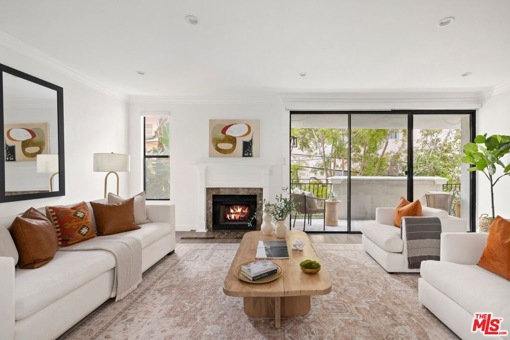 Welcome to this bright and elegant, beautifully updated Westwood condo, complete with stylish finishes and materials throughout. Enjoy multiple balconies with treetop views, each accessed by the living, dining, and primary. In the living room, discover spaces awash in light, a wood-burning fireplace with traditional mantle, and wet bar adjacent to the formal dining room. The kitchen is expertly appointed with quartz countertops and backsplash, a farm sink, and top-notch appliances including warming drawer and wine refrigerator. The spacious primary opens to a private balcony and includes an en-suite bath with dual-sink vanity, an abundance of cabinetry, and separate soaking tub and rainwater shower. The walk-in closet contains custom built-ins for maximizing use of space. The secondary bedroom and bath are also updated with modern finishes, including marble-lined walls and showers in all bathrooms, and in-unit laundry features side-by-side washer and dryer. Building amenities and conveniences include a whirlpool spa, sauna, and secured, controlled-access subterranean garage with two tandem parking spots. Experience a fresh, coveted lifestyle in a central location, convenient to UCLA, freeways, Santa Monica, Sawtelle, Westfield Century City, Westwood Village, and the many wonderful entertainment, dining, and shopping options of the Westside.