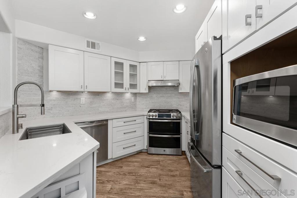 Elegantly upgraded and bathed in natural light, this beautiful corner unit in Carmel Mountain Ranch offers a perfect blend of comfort, style, and functionality. The open, airy floorplan features Italian porcelain plank tile flooring throughout, adding both sophistication and durability. The spacious loft provides an ideal space for a home office or additional living area. Culinary enthusiasts will appreciate the high-end kitchen appliances, thoughtfully designed to inspire creativity. Thoughtful upgrades, including a newer HVAC system, recently replaced hot water heater and roof, and timeless plantation shutters, enhance both beauty and practicality. Enjoy a serene garden and pool views from your private haven. You will appreciate the convenience of an attached two-car garage. Located in the highly sought-after Rancho Bernardo School District, this home offers easy access to shopping, dining, and major freeways, while the HOA provides exceptional amenities including a sparkling pool, spa, BBQ areas, and impeccably maintained grounds—creating a lifestyle of ease and elegance.
