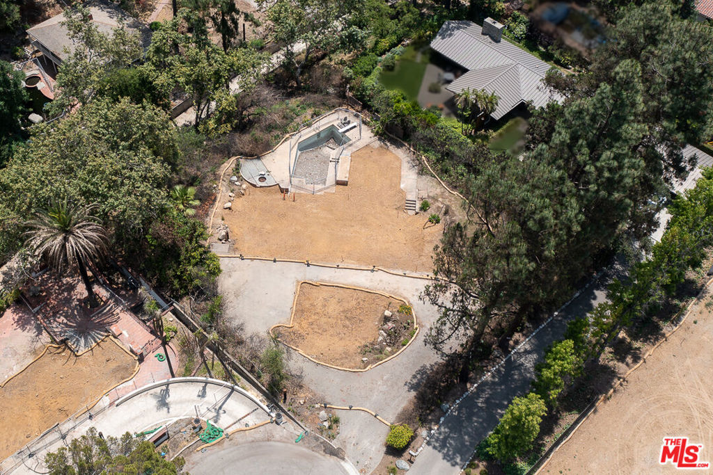Discover an extraordinary opportunity to create your dream home on this spectacular half-acre lot, ideally situated on the cul-de-sac of East Palm Street in Altadena, offering sweeping views of the majestic San Gabriel Mountains. Though the original mid-century post-and-beam home, designed in 1960 by renowned local architects John Nyberg & Harold Bissner, was lost in the Eaton fire in January 2025, its legacy lives on. The original architectural plans are intact and will be included with the sale, providing an incredible foundation for recreating a masterpiece or inspiring a new vision that harmonizes with the property's natural splendor. Adding to the immediate value and potential, the pool structure and an elegant stone paver circular driveway remain at the site, ready to be incorporated into your future design. This unique parcel is an invitation to rebuild, reimagine, and reside in a truly iconic setting.