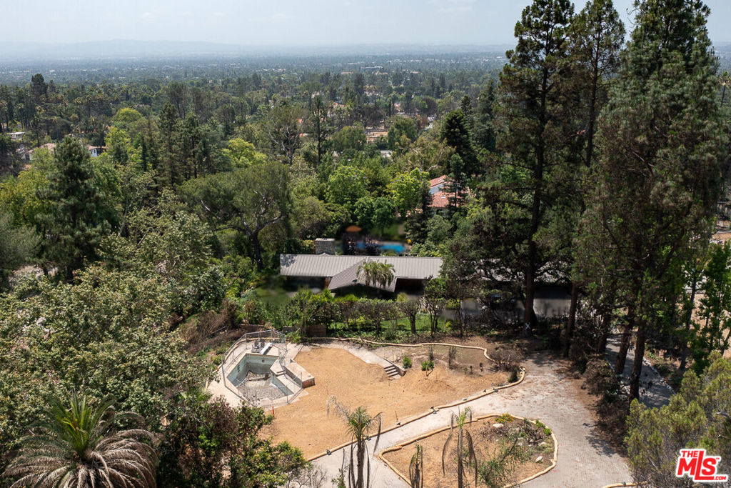Discover an extraordinary opportunity to create your dream home on this spectacular half-acre lot, ideally situated on the cul-de-sac of East Palm Street in Altadena, offering sweeping views of the majestic San Gabriel Mountains. Though the original mid-century post-and-beam home, designed in 1960 by renowned local architects John Nyberg & Harold Bissner, was lost in the Eaton fire in January 2025, its legacy lives on. The original architectural plans are intact and will be included with the sale, providing an incredible foundation for recreating a masterpiece or inspiring a new vision that harmonizes with the property's natural splendor. Adding to the immediate value and potential, the pool structure and an elegant stone paver circular driveway remain at the site, ready to be incorporated into your future design. This unique parcel is an invitation to rebuild, reimagine, and reside in a truly iconic setting.