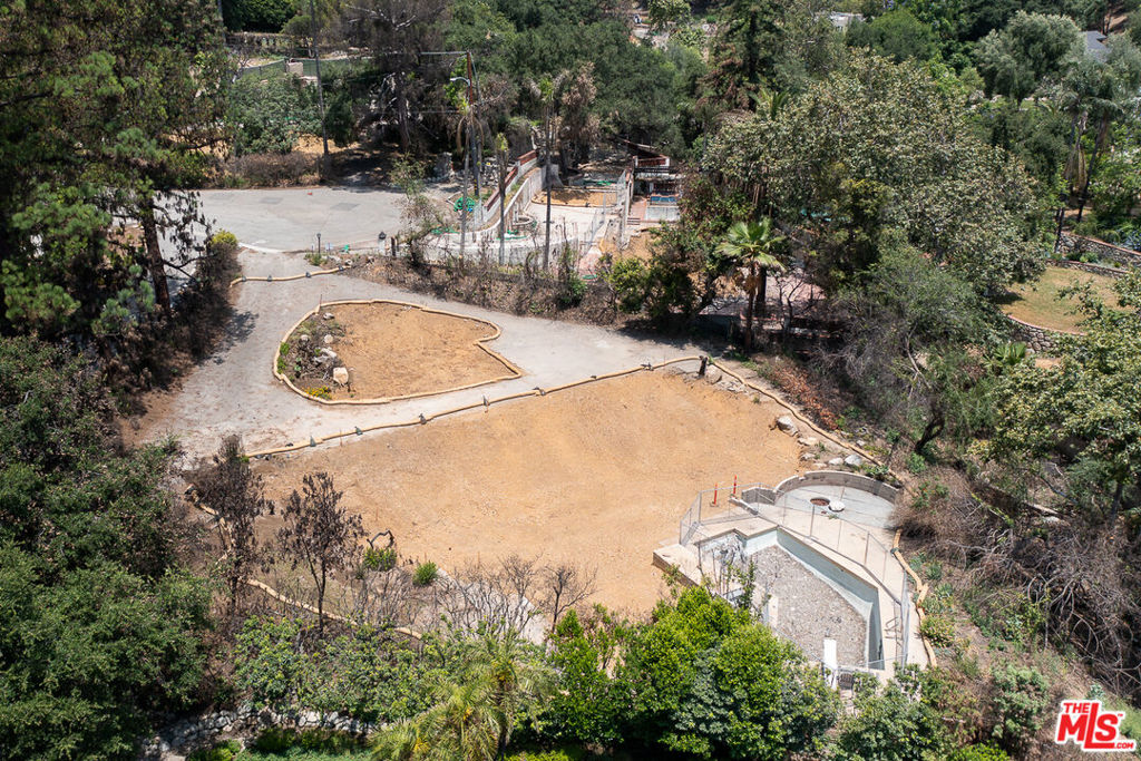 Discover an extraordinary opportunity to create your dream home on this spectacular half-acre lot, ideally situated on the cul-de-sac of East Palm Street in Altadena, offering sweeping views of the majestic San Gabriel Mountains. Though the original mid-century post-and-beam home, designed in 1960 by renowned local architects John Nyberg & Harold Bissner, was lost in the Eaton fire in January 2025, its legacy lives on. The original architectural plans are intact and will be included with the sale, providing an incredible foundation for recreating a masterpiece or inspiring a new vision that harmonizes with the property's natural splendor. Adding to the immediate value and potential, the pool structure and an elegant stone paver circular driveway remain at the site, ready to be incorporated into your future design. This unique parcel is an invitation to rebuild, reimagine, and reside in a truly iconic setting.