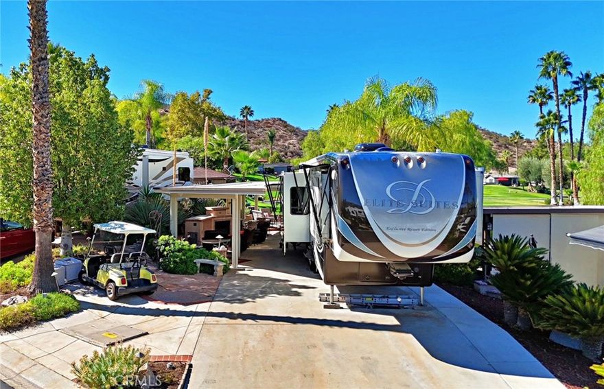 Welcome to "THE LOOP"! A sought after location within the resort. With a custom alumawood structure, sweeping golf course views, mature landscape, water features and surrounding countryside makes this lot a must see on your property tour. Just twenty minutes outside of Temecula, Ca. in the hills of wine country at an elevation of eighteen hundred feet makes for comfortable living any time of year. With Palm Desert and high end shopping on El Paseo forty five minutes away and the coast just over an hour, this resort RV lot is in the ultimate Southern California location. The lot itself is situated on a slight corner facing north/west for early morning sun and beautiful evening sunsets. An established shade tree and stone walking path just beyond the golf cart area, frames the entrance and welcomes you into a bistro seating area, TV niche and gas fireplace. Chef style galley kitchen with overhead TV captures endless views of the fairway, water features and palm trees. Stainless steel grill, drawers, corner sink and dual mini fridge(s) and adjacent bar provides plenty of room to host guests. A formal dining area allows for comfortable seating. An additional raised seating area towards the rear of the lot offers a place to relax and take in incredible views. Resort boasts a 14 hole executive golf course, 5 pools, spas, tennis courts, pickleball courts (several just added), dog park, general market, coming soon restaurant, laundry facilities/showers, fishing lake and variety of resort activities throughout the year. No age restriction.