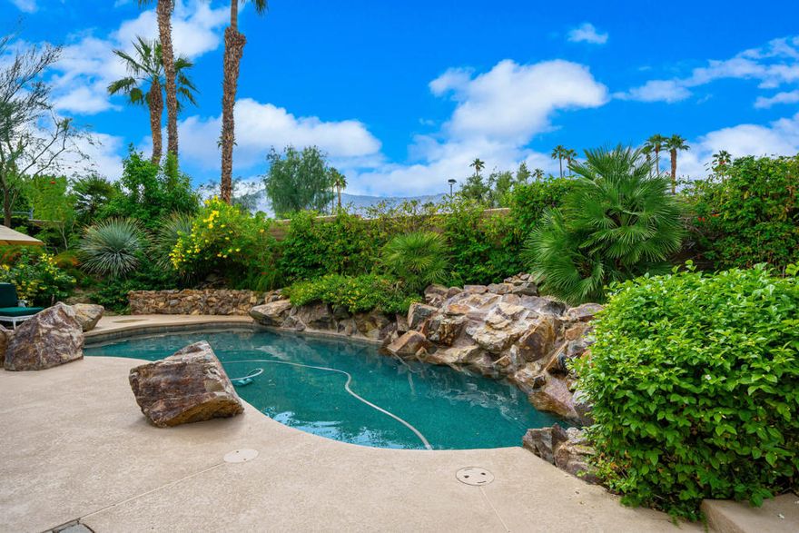 Welcome to this beautifully upgraded 4-bedroom, 4-bathroom residence, ideally positioned on a desirable secluded corner lot within the guard-gated community of Monterra in South Palm Desert. Capturing breathtaking west-facing mountain views, this home perfectly blends sophisticated design, modern comfort, and resort-style living. Step inside to soaring high ceilings, elegant travertine and wood flooring, and a spacious open layout designed for effortless entertaining. The chef's kitchen showcases granite countertops, stainless steel appliances, and a Sub-Zero refrigerator, while multiple fireplaces in the living room and primary suite create warm, inviting spaces to unwind. Outdoors, enjoy your private resort oasis featuring three patios with misters and drop shades; also, including a custom side patio surrounded by pavers, complete with a pergola and seating wall for entertaining and year-round comfort. Bask by the saltwater pool and spa with a tranquil waterfall, or gather on the covered side patio for dining al fresco beneath the desert sky. Every detail has been thoughtfully designed for comfort and efficiency, including owned solar panels, a commercial-grade misting system, custom screens on French doors, ceiling fans, a whole-home instant hot water and water softener, and a kitchen filtration system. The three-car garage provides ample space for vehicles and storage, while low HOA fees add exceptional value. This stunning home embodies the essence of desert elegance, privacy, and functionality--the perfect retreat for full-time residents or seasonal escapes.