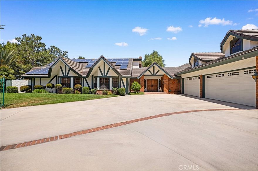 Custom home equipped with Solar panels on a very private gated 1.5 acre lot. 270 degree panoramic view of Mountains, Hills and Valley. Formal living room with marble fireplace and view, large dining room with view, large family room fireplace, view and adjoining study. Spacious kitchen with center island, 2 dishwashers, commercial grade exhaust fan, Jenn-Air 6 burner gas range, Lynx wok burner, Thermador 6 station induction unit and a built-in oversized Electrolux side by side refrigerator/freezer. plus 2 pantries and a large breakfast room with view. 5 spacious en-suite bedrooms and 7 bathrooms. Spacious laundry room with folding tables. the lower level includes an additional 1,300 sqft of space for relaxation with a bar and wine cellar. Beautiful custom pool/spa. Koi pond. Plenty of space outdoors for Children to play and for vegetable gardening, fruit trees and livestock. long private gated driveway with 4 car garage and plenty of space for cars and RV parking. Close and convenient to the Cities of Walnut, Diamond Bar and Rowland Heights and only minutes to Orange County. No Mello Roos or HOA fees.