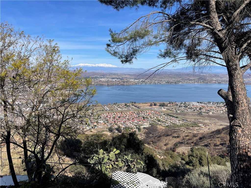 Welcome to an exceptional opportunity to own a piece of Southern California's natural beauty. Nestled on 14.19 private acres along the scenic Ortega Highway. This custom built 3,154 sq ft estate offers sweeping panoramic views of rolling hills, canyons and the Lake Elsinore valley below. Backing up to the Cleveland National Forest, you'll enjoy maximum privacy. Originally built in 1956, this charming residence blends timeless character with generous living space, ideal for a peaceful retreat, family compound, or investment property. The expansive floor plan showcasing large windows, drawing the outdoors in with endless natural light and stunning views. This three bedroom and three full bathrooms featuring two private suites with ensuite bath and private view deck on the upper level, one very private bedroom and ensuite bathroom on the lower floor perfect for guests or a downstairs gaming room. With sliding glass doors for easy access to create a garden private patio; you will find the view exfiltrating! So much to do here in Lake Elsinore. You won't want to miss the Historic Downtown Main Street, where charming shops, local cafe and weekend markets bring community to life. It's a perfect balance of rural seclusion and small town charm. Lake Elsinore is also well known for Extreme Sports, Baseball at the Storm Stadium and hosting many other community events. Don't miss your chance to own a rare slice of California beauty, just a short drive from the coast, historic San Juan Capistrano and the heart of Lake Elsinore.