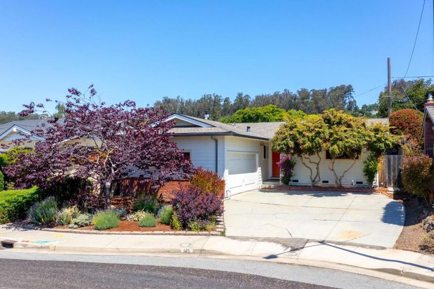 Tucked away in Santa Cruz's Banana Belt this beautiful 2-bedroom, 2 bath lovely mid-century influenced single level home is surrounded by an amazing garden oasis. The updated kitchen is a joy to cook in including stainless steel appliances, Thermador gas range all surrounded with detailed custom wood cabinetry allowing spacious Caesar stone counter areas. Enjoy an open floor plan combining the large dining and family rooms with high vaulted ceilings and wood beams. The mature landscaping and plantings offer a tranquil escape with various sitting areas to enjoy. The bright main bedroom is spacious and has more custom hardwood built-ins including slow close drawers. The main bath is light and bright with a pedestal sink and hex tile flooring. The nicely updated hall bath includes a large soaker tub. The second bedroom is used currently as a bright office with windows and built ins. Large driveway and a 2-car attached garage offers plenty of room.