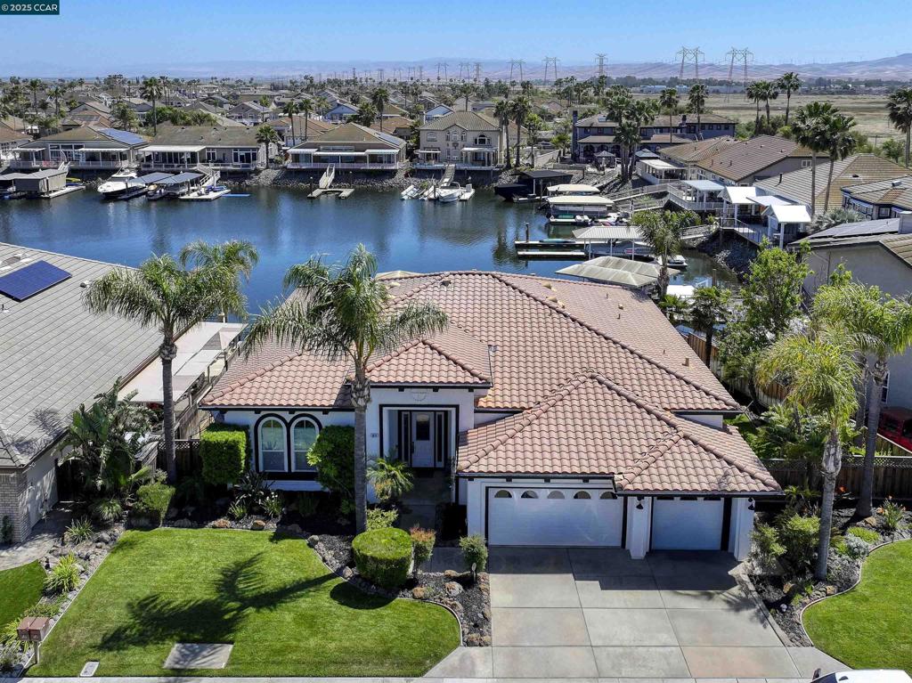 Beautifully remodeled single story waterfront home with gorgeous water views. Sought after court location with southern exposure. Rarely available popular Miramar Plan 1. Spacious open floor plan with soaring ceilings and lots of natural light, features a massive great room, 4 bedrooms and 3 bathrooms. Shows like a model home with custom touches throughout. Remodeled chef's kitchen features quartz counters, stainless steel appliances (including double oven), a huge island with bar seating and a large walk-in pantry. Luxurious primary suite features a fireplace, gorgeous water views and sliding glass door to covered deck. Spa-like primary bathroom features jetted tub, a walk-in shower and a huge walk-in closet. Secondary bedroom suite features private bathroom. Large office / game room / optional 4th bedroom features water views and custom barn doors. Beautiful newer vinyl plank flooring. Gorgeous covered deck with ceiling fans. U-shaped vinyl dock. Oversized lot with beautifully landscaped yard, and perhaps room for a pool! Perfect for indoor/outdoor living and entertaining. Access to over a thousand miles of delta waterways from your backyard!